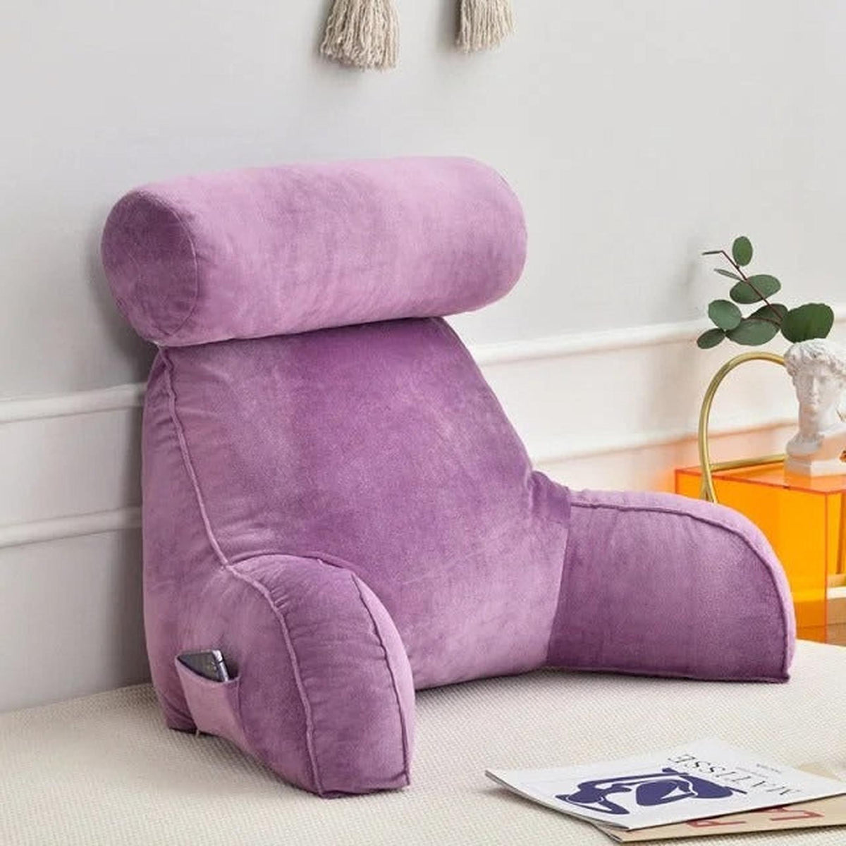 Purple velour adjustable backrest pillow with arms, headrest, and side pocket for phone.