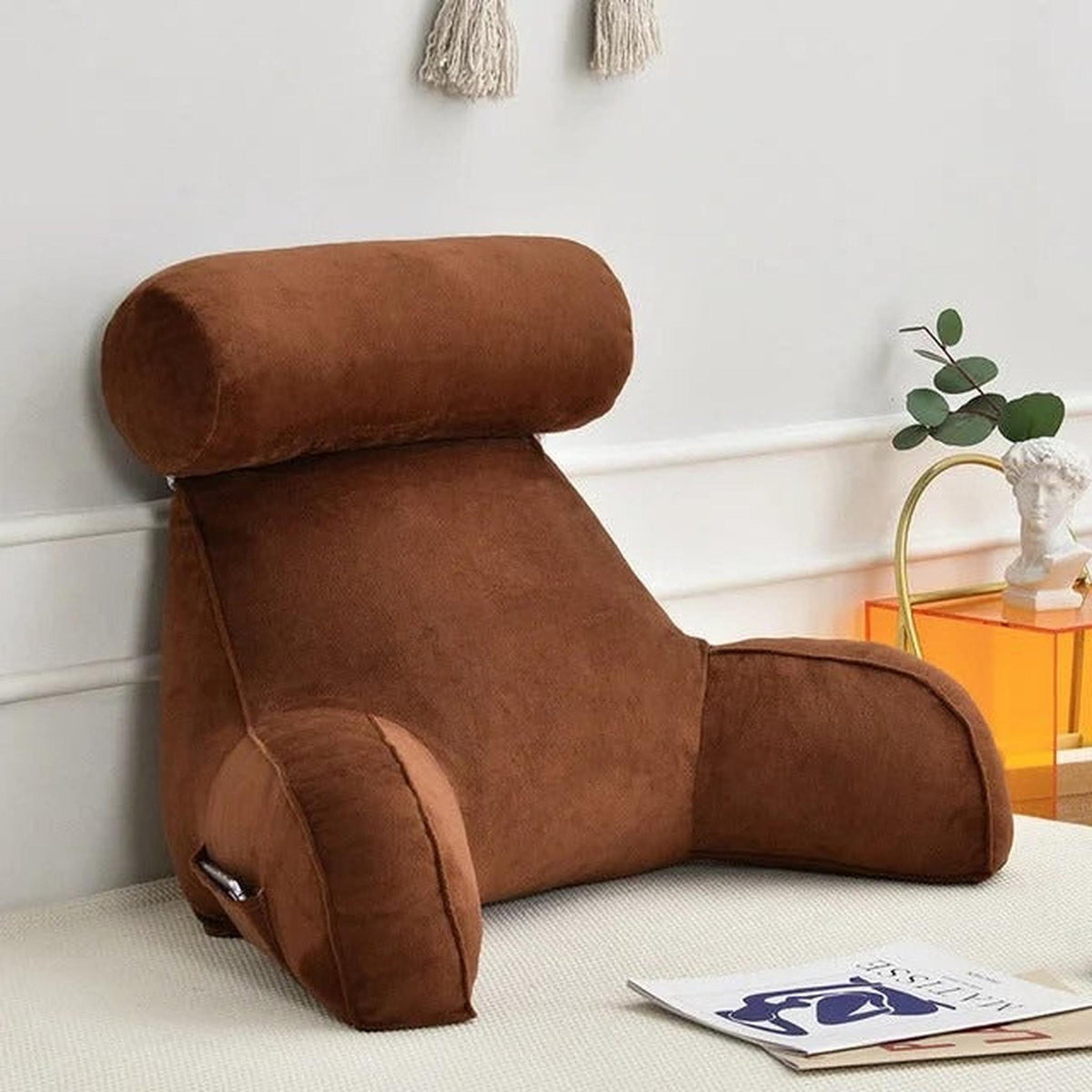 Brown velour adjustable backrest pillow with arms and a side pocket, ideal for bed or sofa.