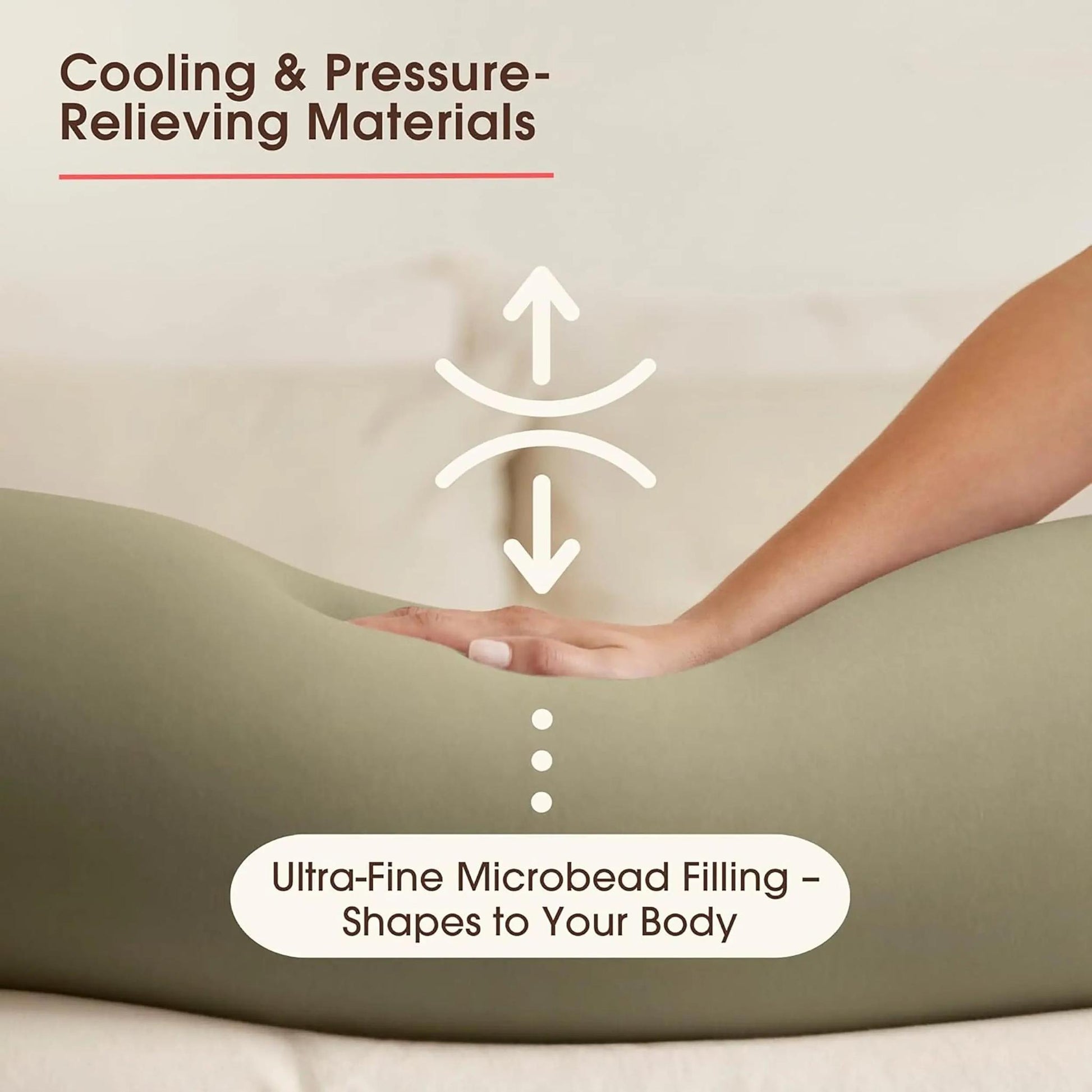 Hand pressing into a light green U-shaped pregnancy pillow, highlighting its micro-bead filling.