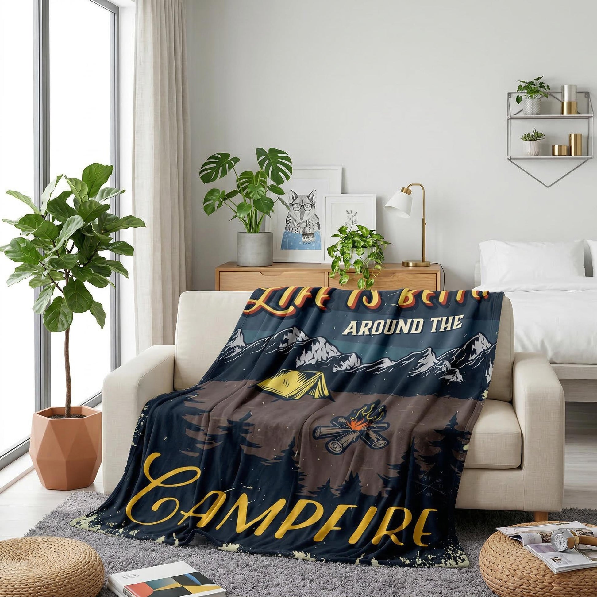 American Retro Landscape Flannel Blanket with "Life is Better Around the Campfire" design, draped on a white sofa.