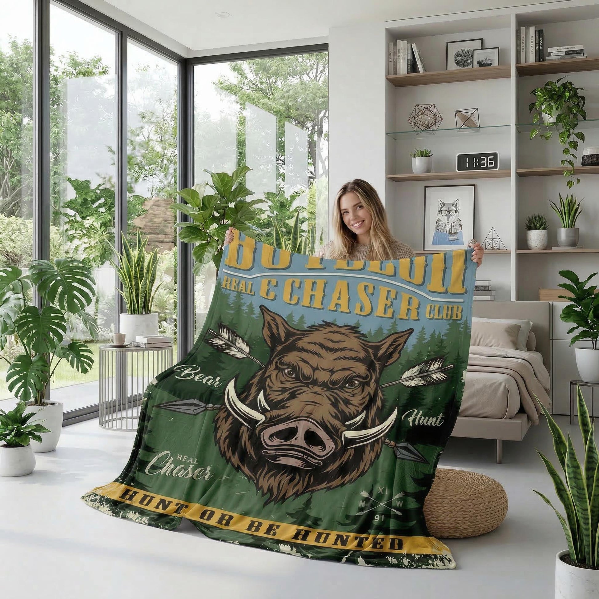 Woman holding a green American Retro Landscape Flannel Blanket with a wild boar design and "Real Chaser Club" text.