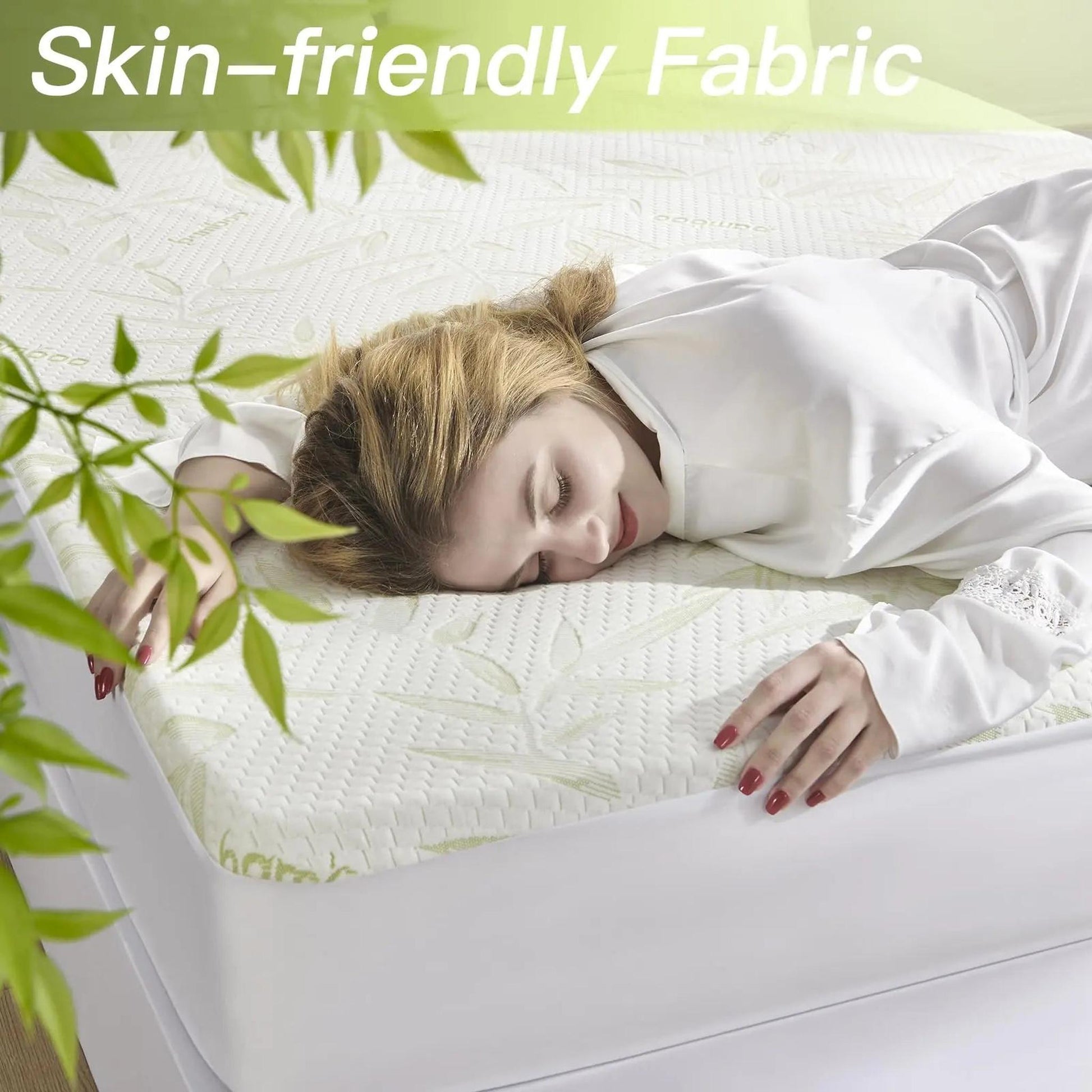 Woman sleeping comfortably on a white bamboo fiber mattress protector with a subtle leaf pattern.