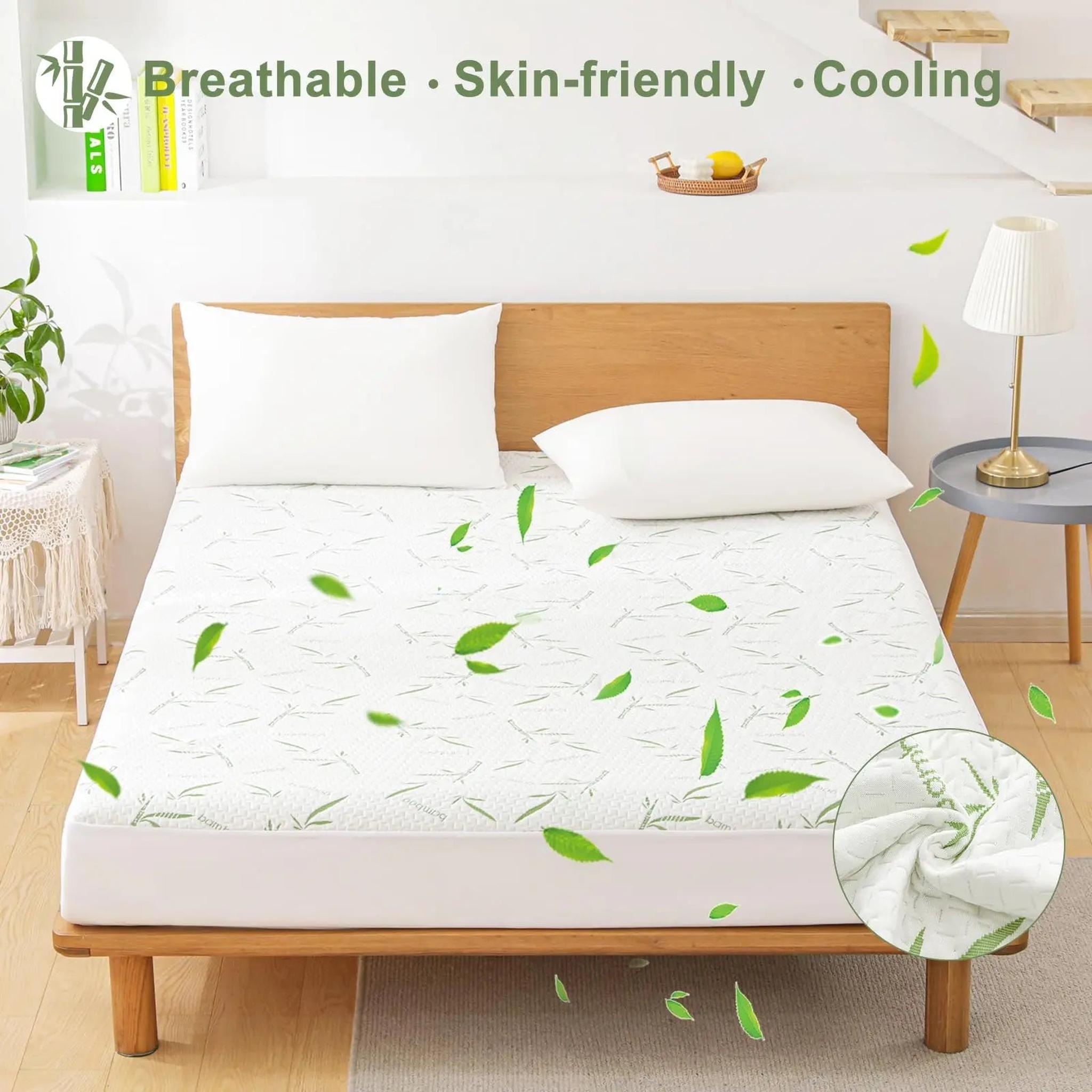 White bamboo fiber fitted mattress protector with subtle leaf pattern on a bed, showing a quilted texture.