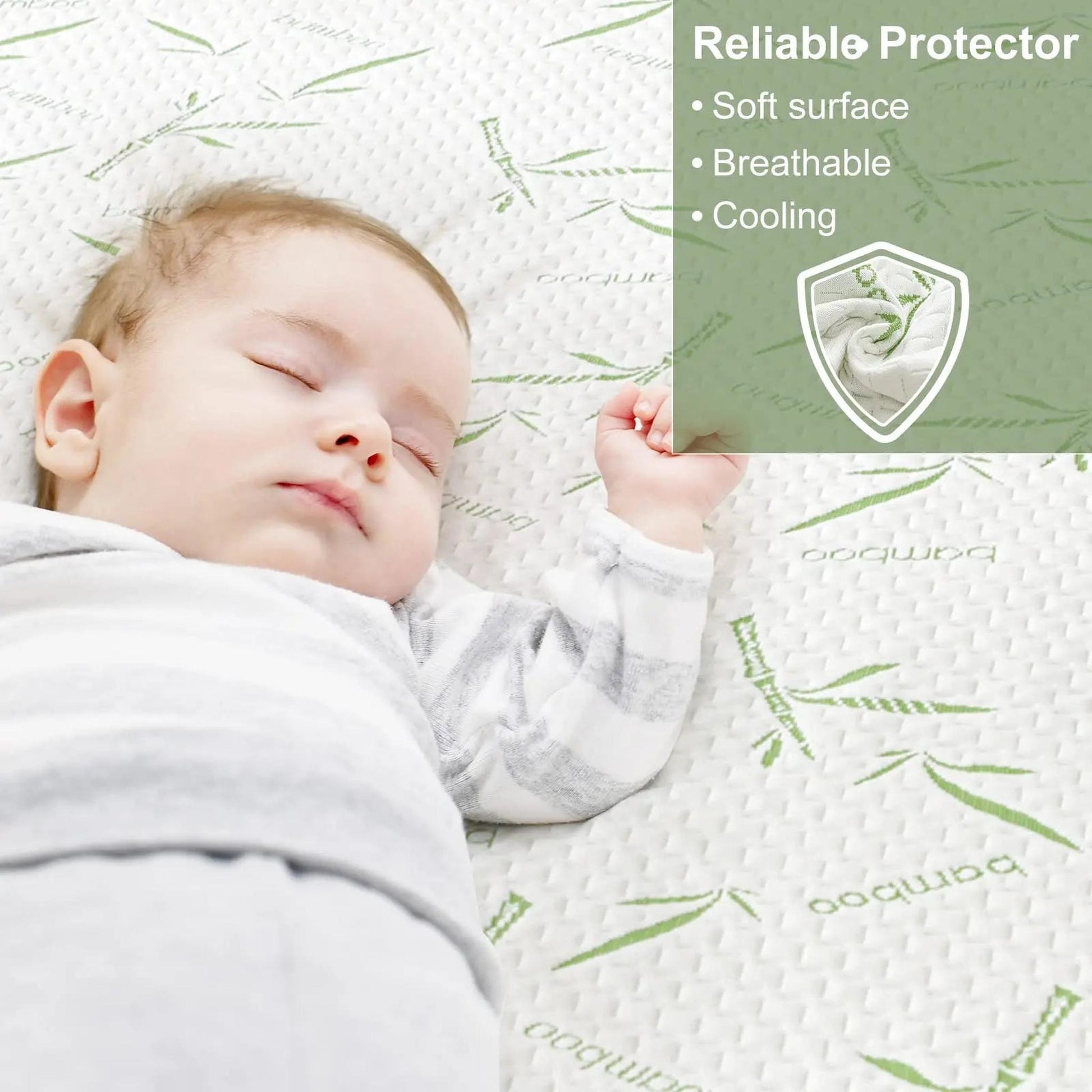 Baby sleeping peacefully on a white bamboo fiber mattress protector with green bamboo leaf patterns.