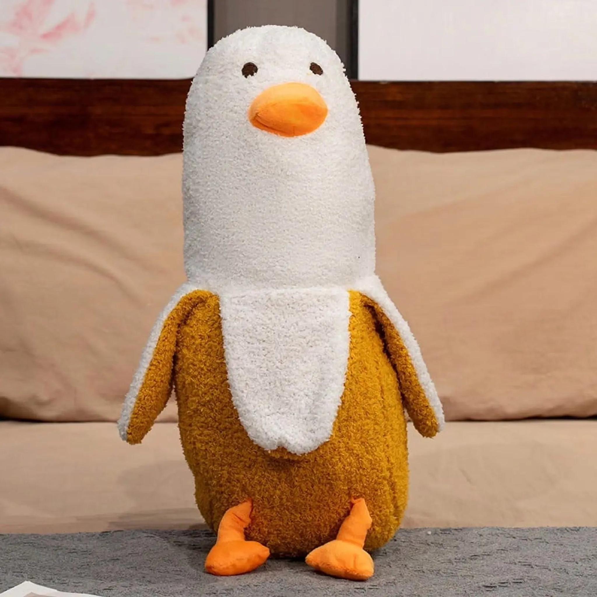 Soft, 20" yellow and white banana duck plush pillow with orange beak and feet.