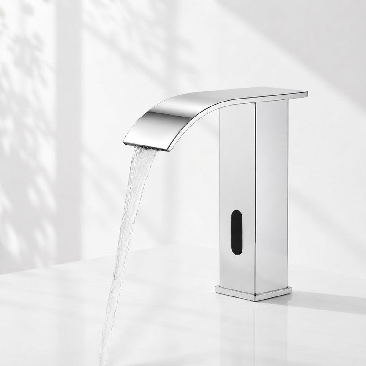 Modern chrome touchless bathroom faucet with a waterfall spout and integrated motion sensor on a white basin.