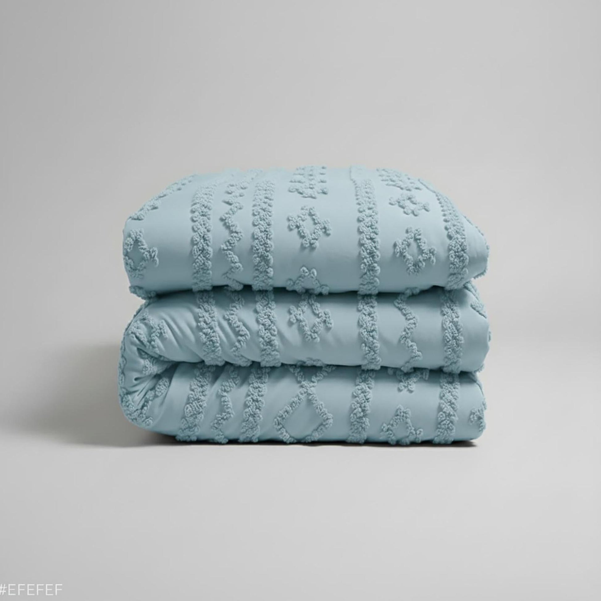 Queen size light blue boho comforter set with soft tufted texture, folded neatly.