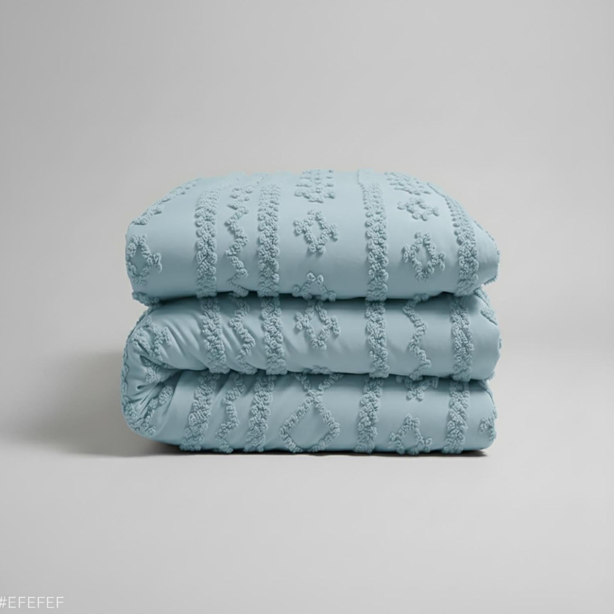 Queen size light blue boho comforter set with soft tufted texture, folded neatly.