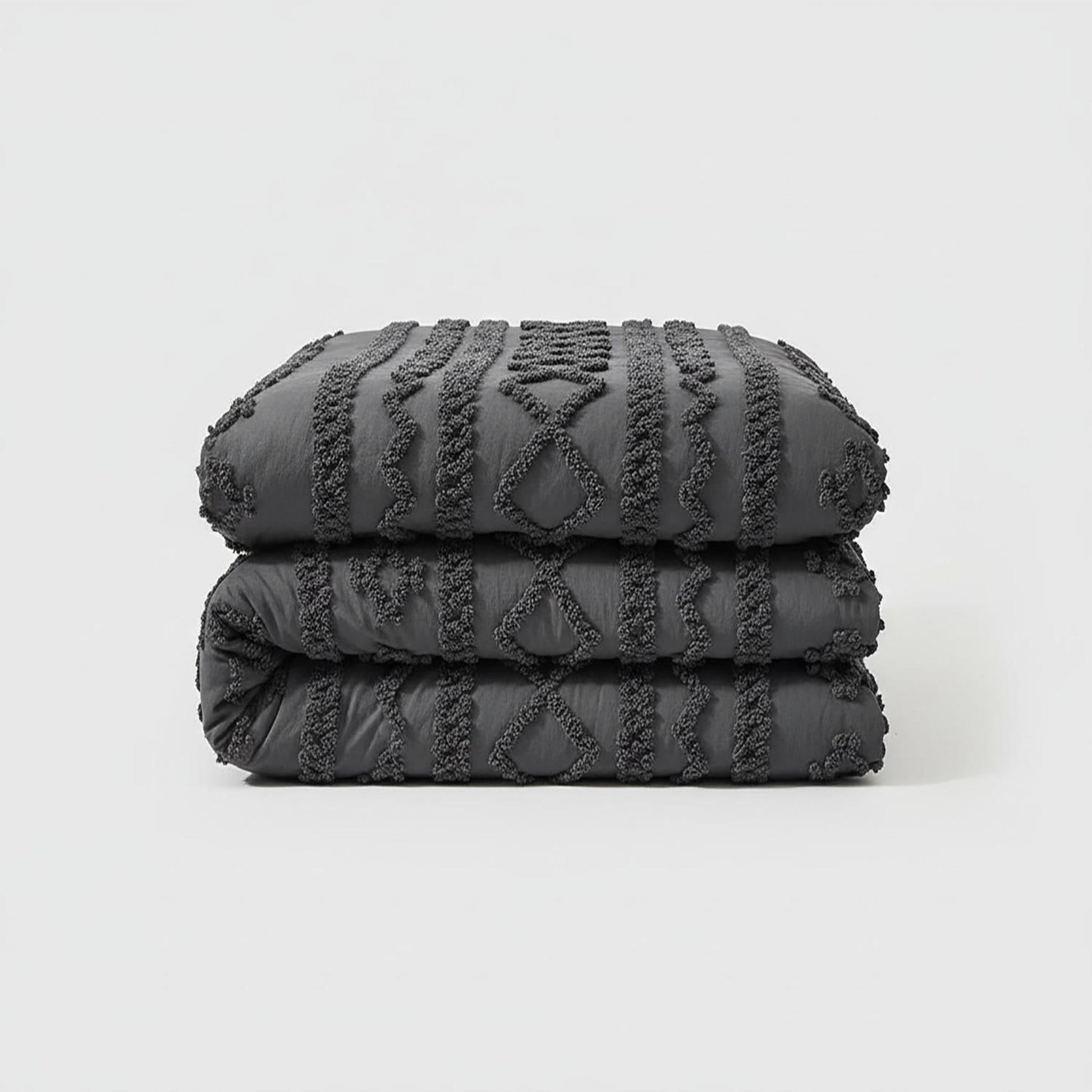 Folded dark gray queen size boho comforter set with soft tufted cotton polyester texture.