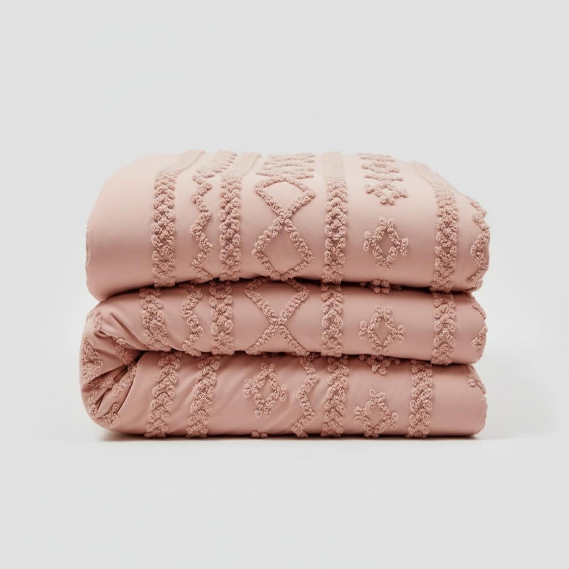 Stacked pink tufted boho comforter set for Queen size bed, featuring soft cotton polyester material.