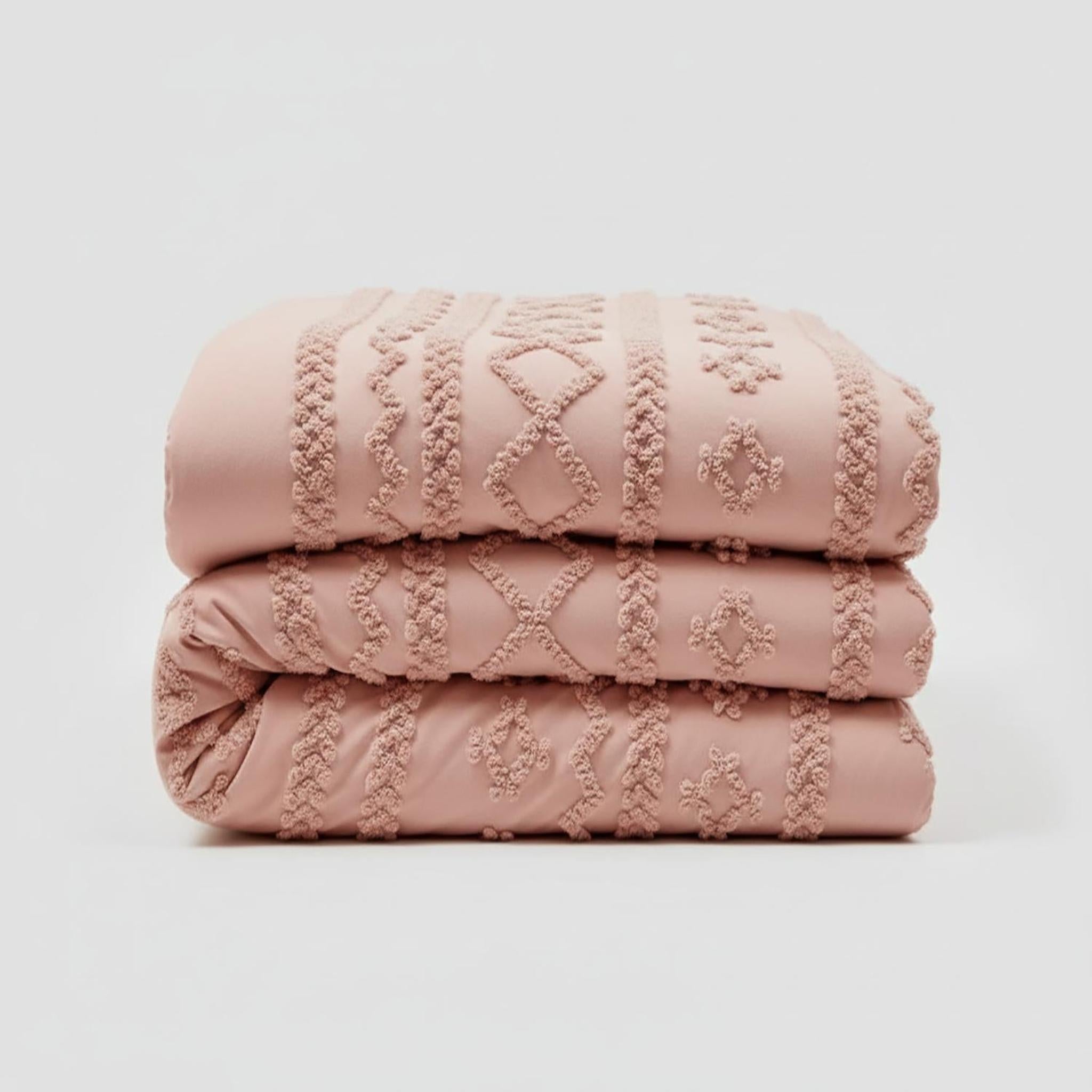 Stacked pink tufted boho comforter set for Queen size bed, featuring soft cotton polyester material.