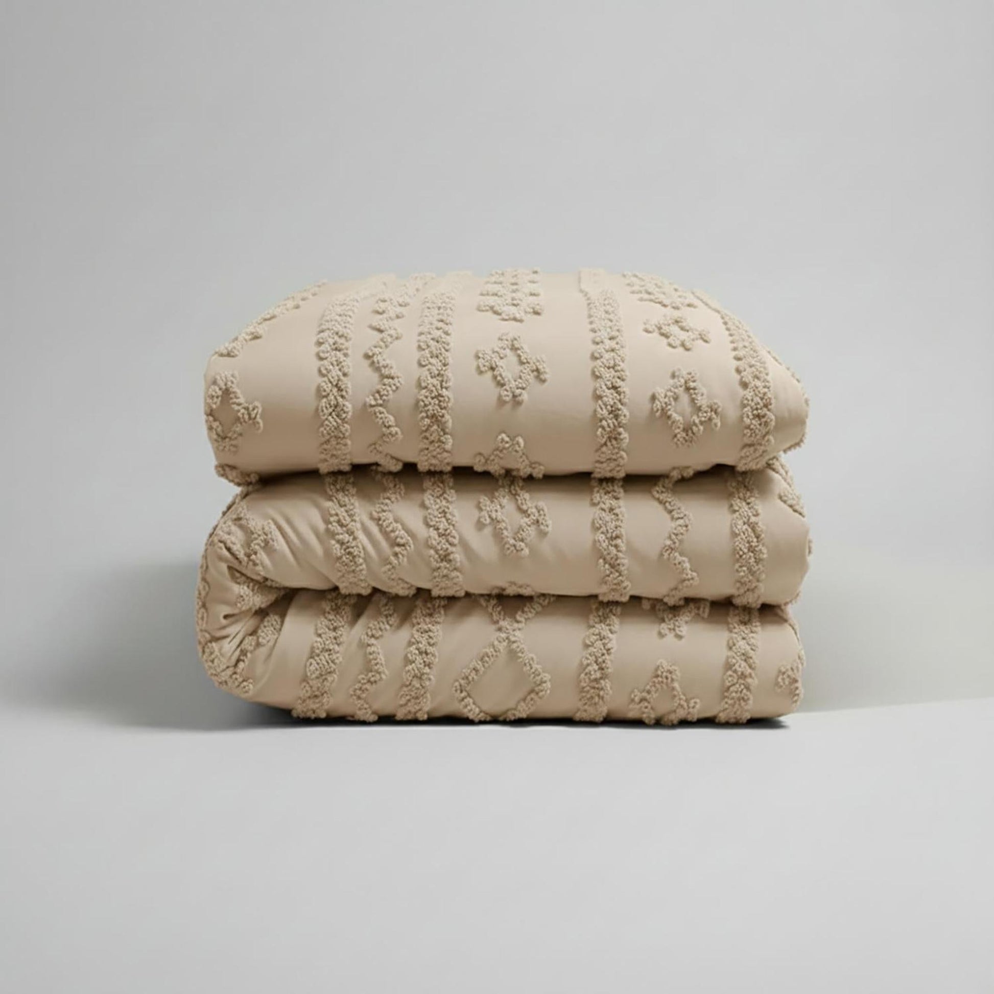 Beige Queen size Boho Comforter Set, folded, showing soft tufted cotton polyester fabric.