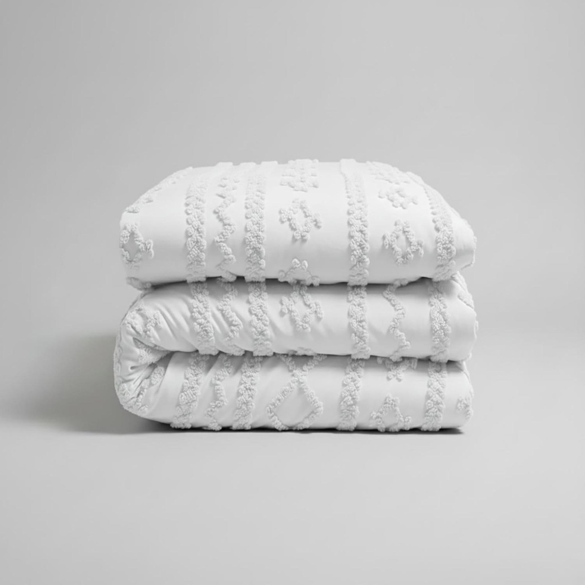White Queen size Boho Comforter Set with soft tufted cotton polyester texture, folded.
