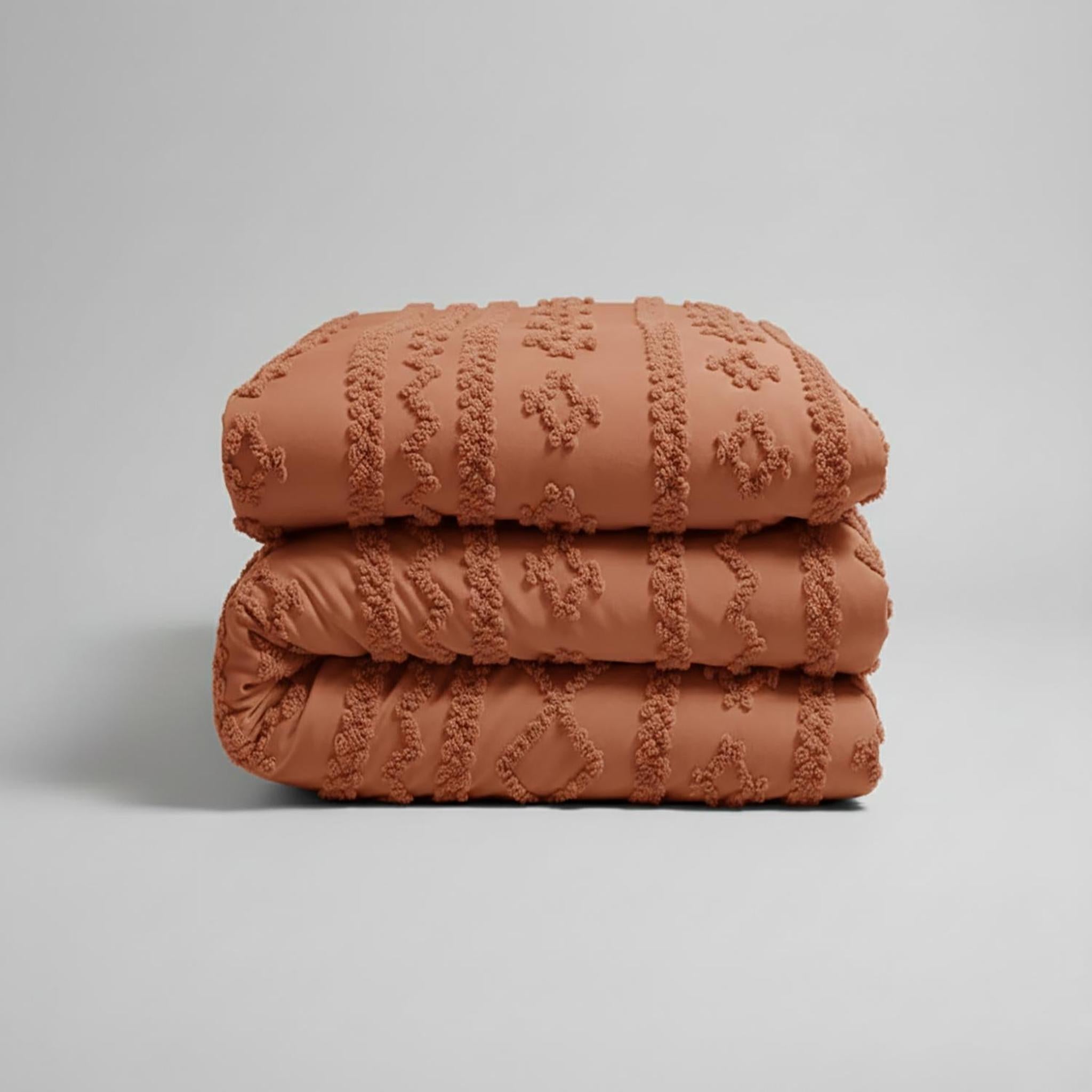 Folded terracotta boho queen comforter set with soft tufted texture.
