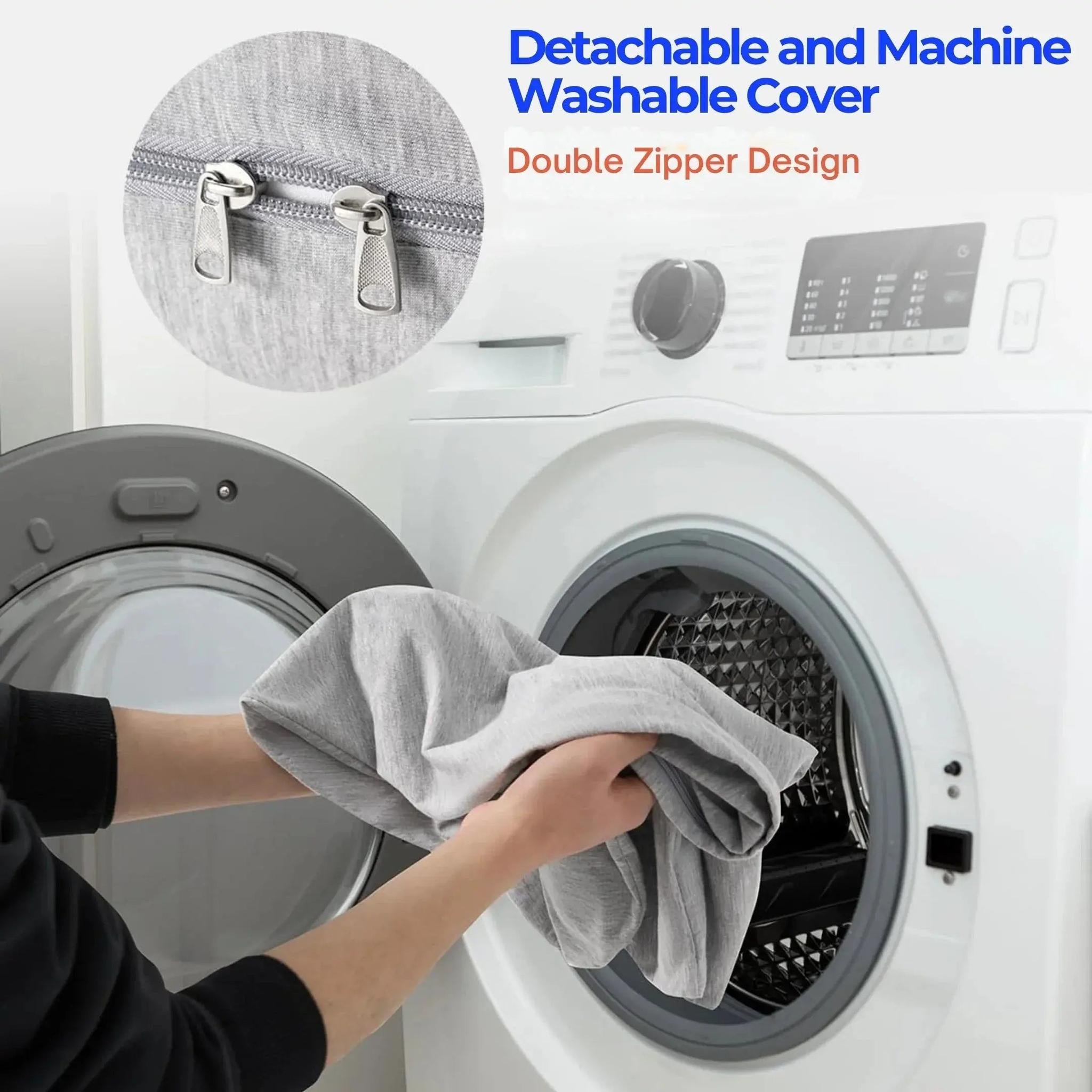 Hands placing a light gray, smooth fabric C-shaped pillow cover with a double zipper into a washing machine.