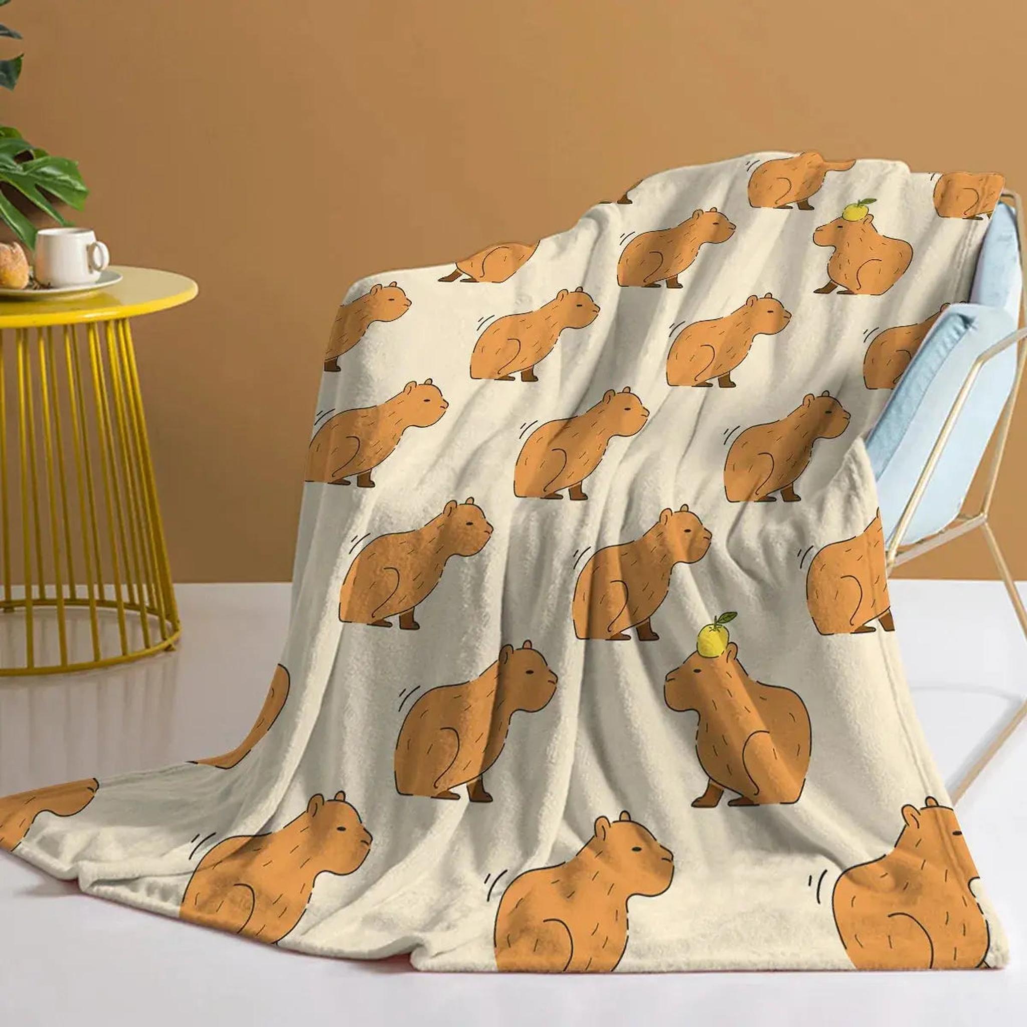 Soft flannel blanket with a playful pattern of brown capybaras, some with fruit on their heads.