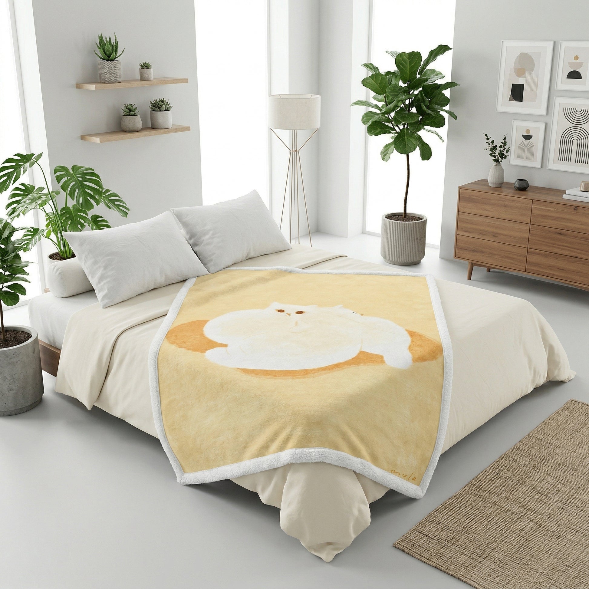 Soft flannel blanket with a fluffy white cat illustration on a warm yellow background, draped on a bed.