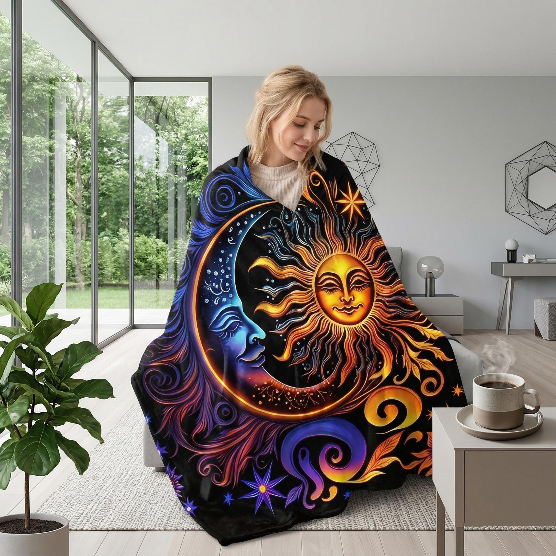 Woman wrapped in a black Celestial Dreams throw blanket with a vibrant sun and moon design.