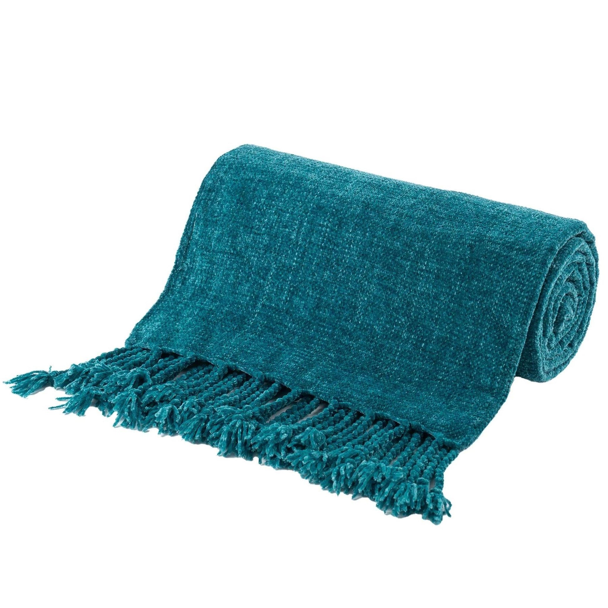 Teal chenille throw blanket with fringe tassels, rolled up on a white background.