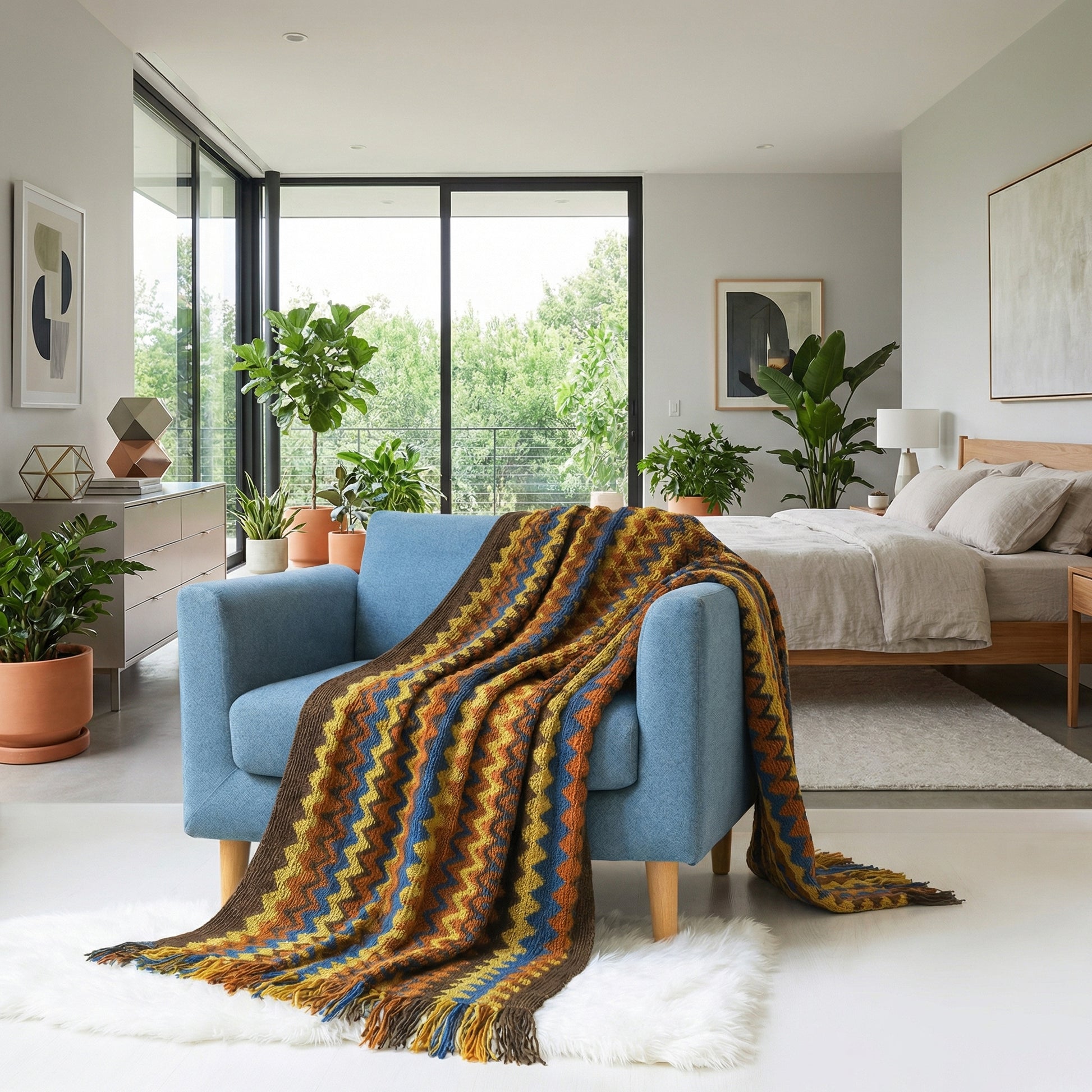 Chic hand-knitted acrylic blanket with a brown, blue, and orange chevron pattern draped over a blue armchair.