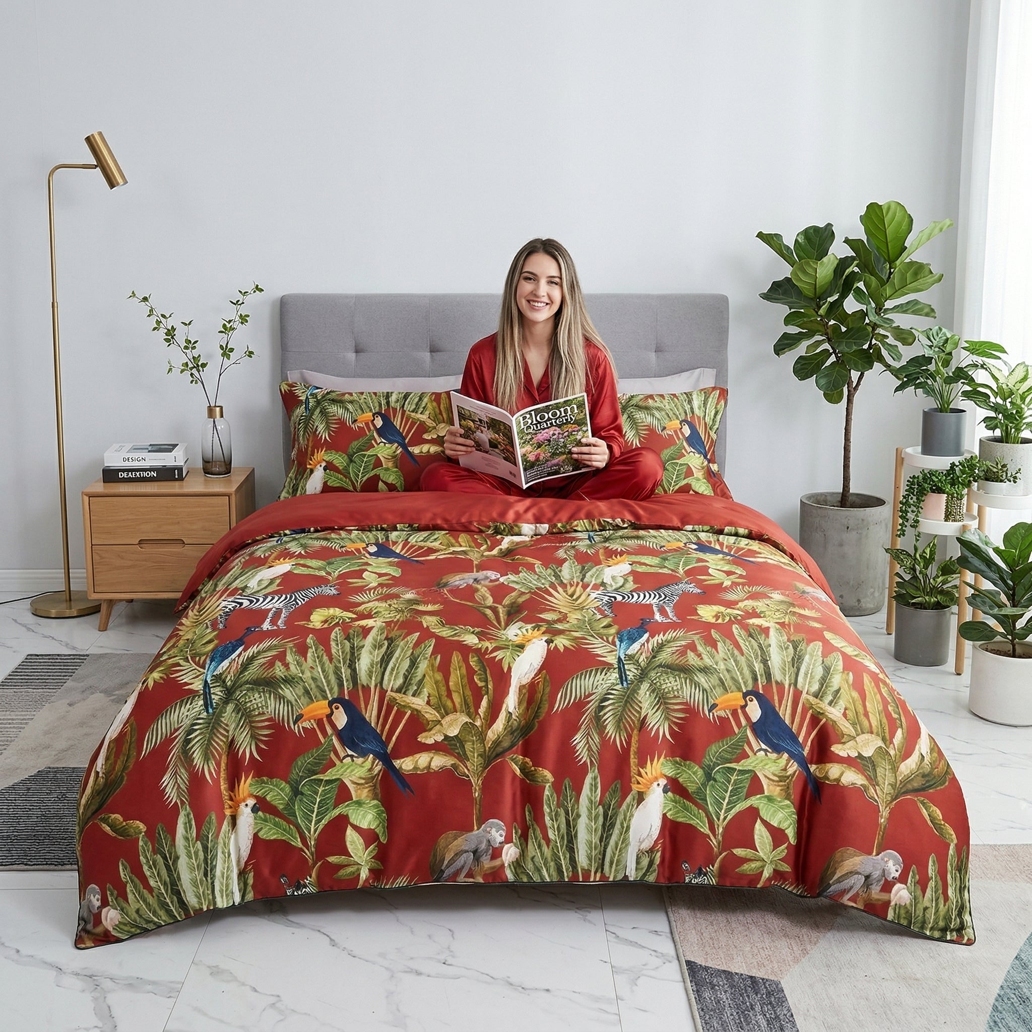 Red Chinoiserie Birds and Flowers cotton duvet cover set with a woman reading on the bed.