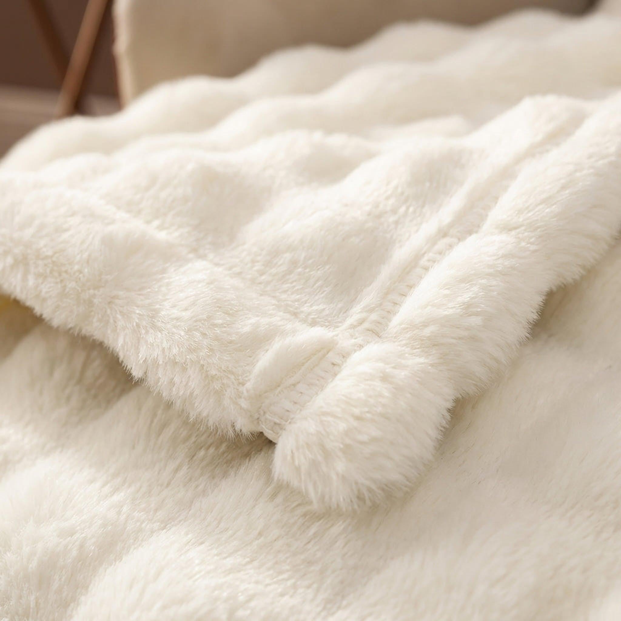 Cream CloudLoom Plush Throw Blanket with a soft, knitted polyester texture and minimalistic design.