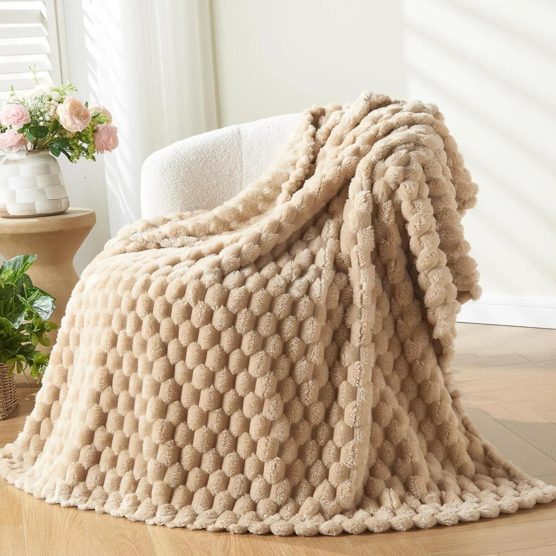 Beige Clouds Jacquard Fleece Blanket draped over a white chair, showcasing its soft 3D cloud texture.
