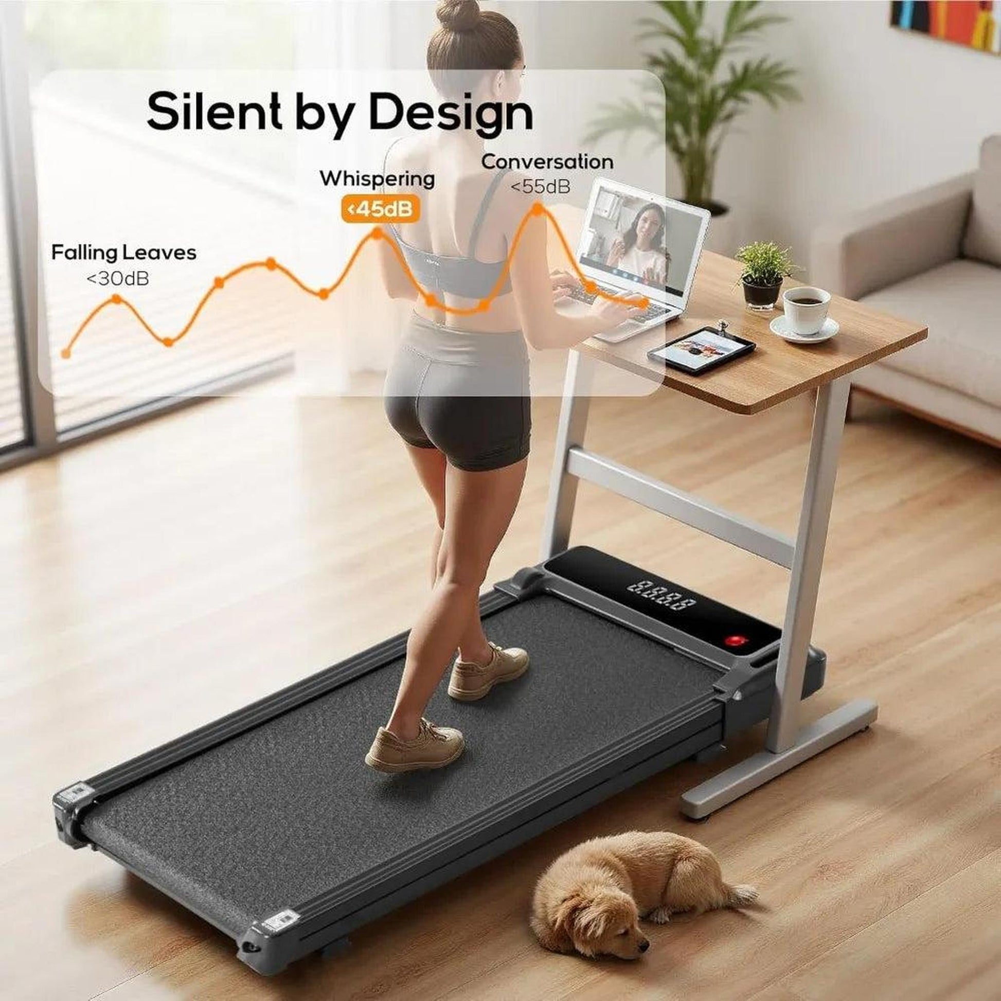Woman walking on a black under-desk treadmill at a wooden standing desk.