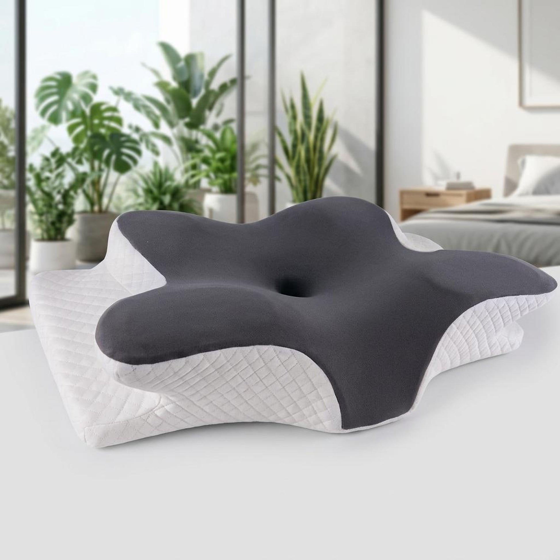 Ergonomic contour memory foam pillow with a dark gray center and quilted white sides for neck support.