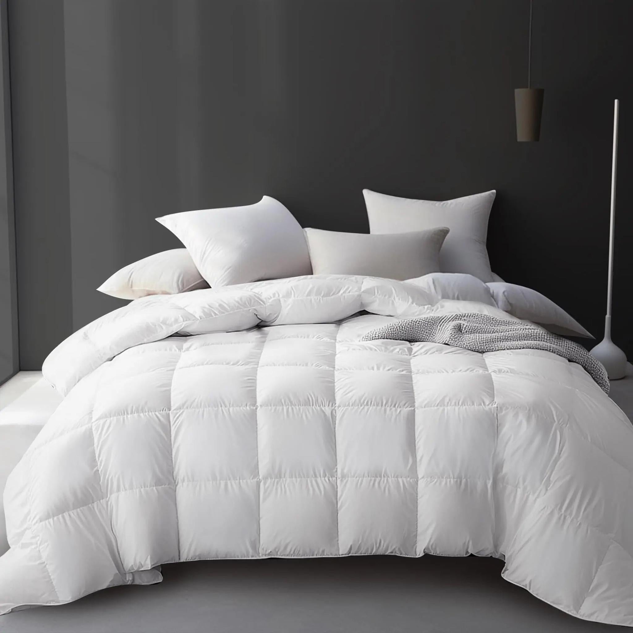 White goose down cooling comforter on a bed with pillows, featuring a quilted design.