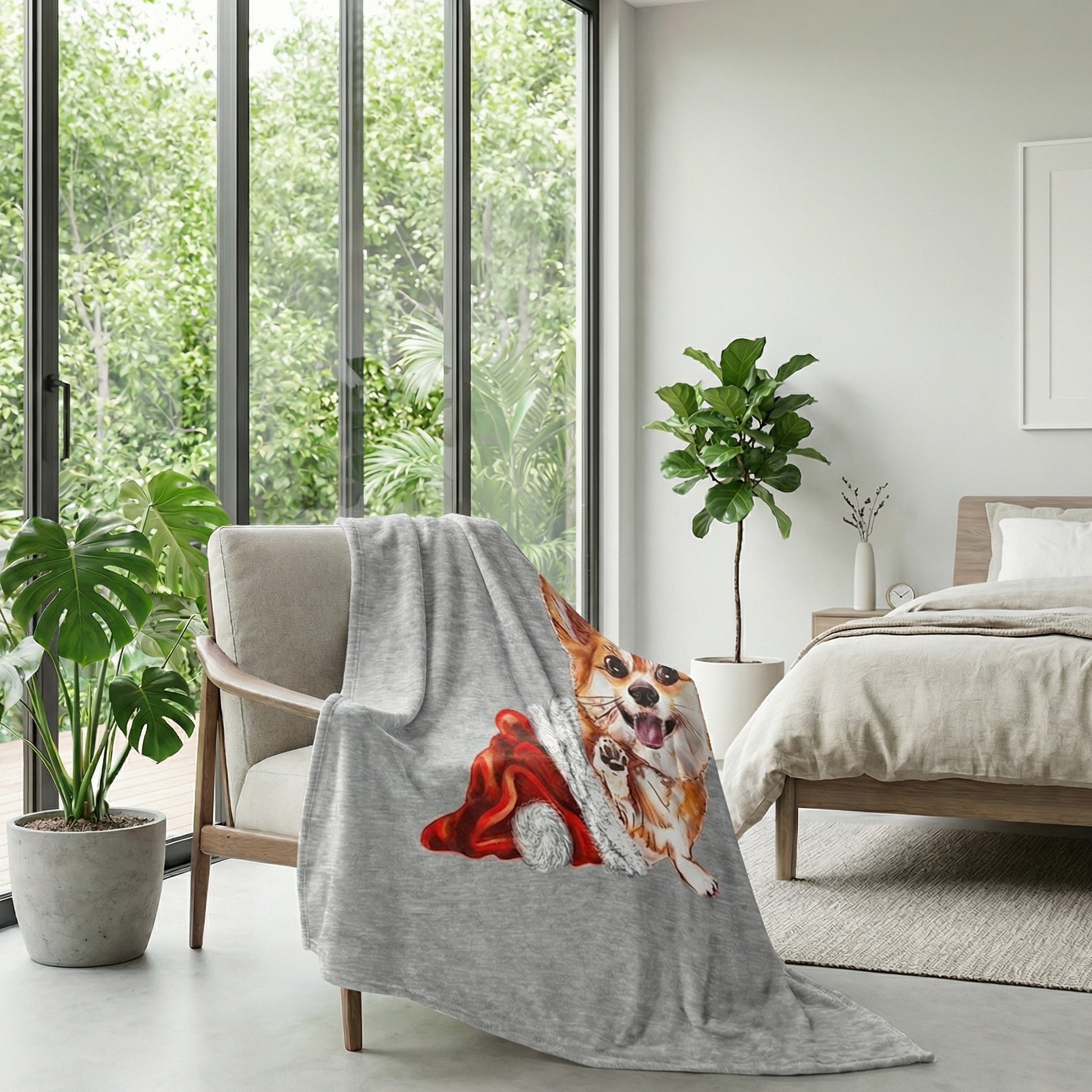 Gray flannel blanket with a playful Corgi wearing a red Santa hat draped over a chair in a bright room.