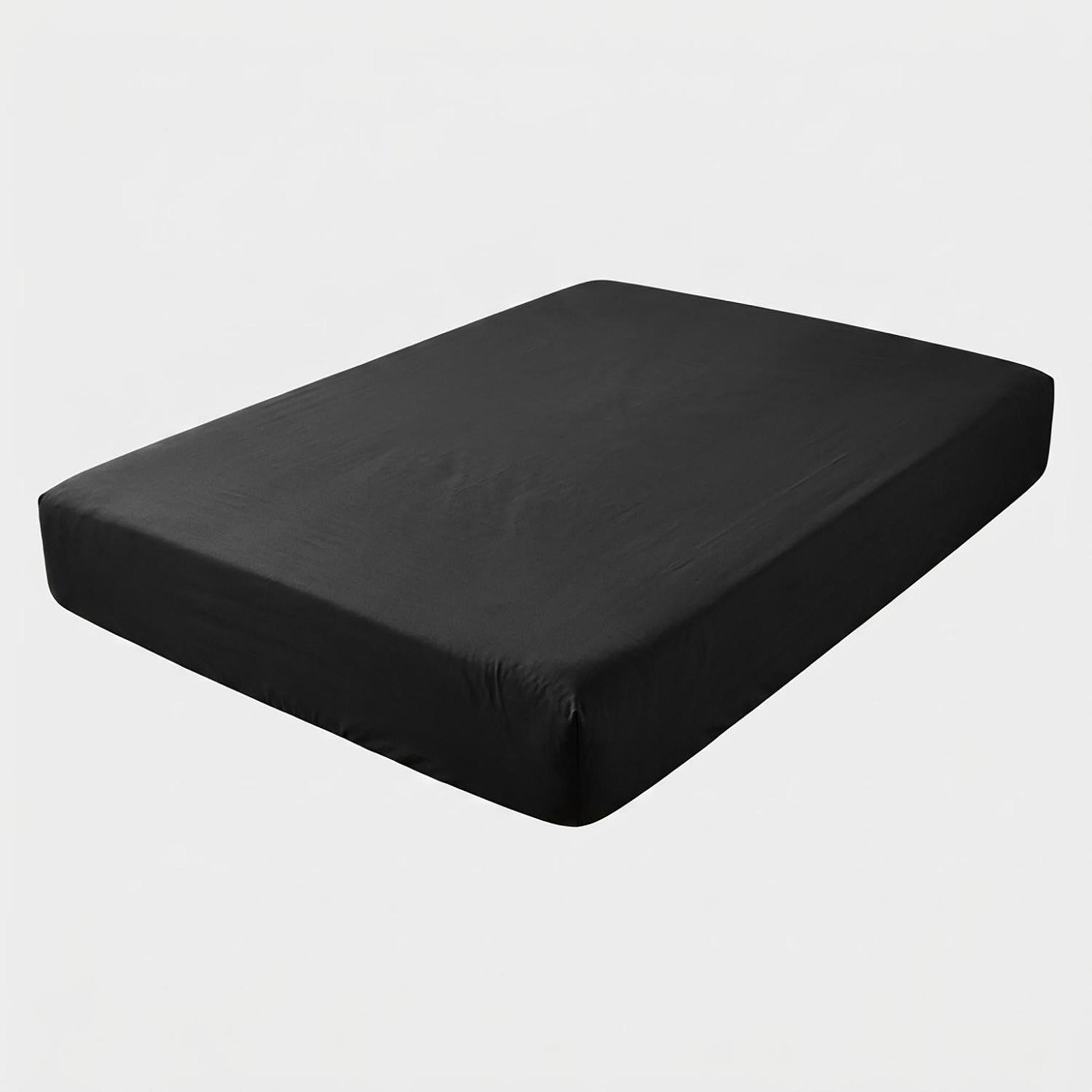 Black cotton fitted sheet on a mattress, showing its smooth texture and snug fit.