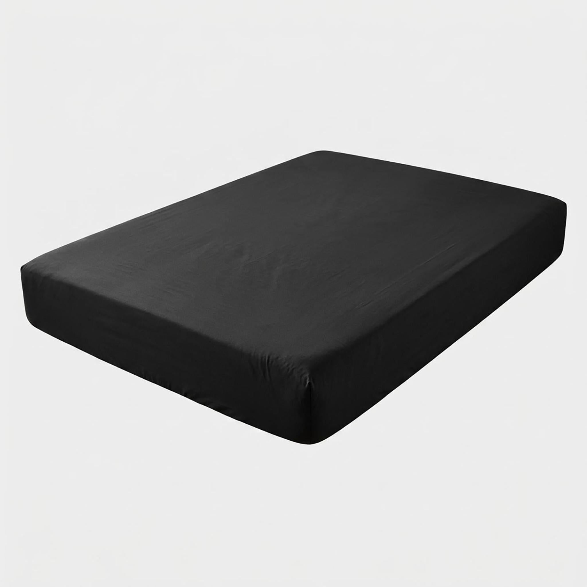 Black cotton fitted sheet on a mattress, showing its smooth texture and snug fit.