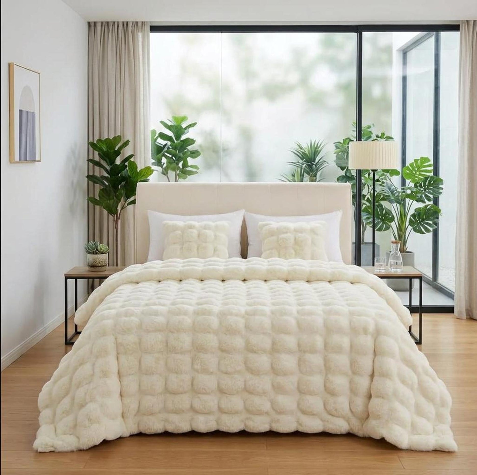 Cream faux rabbit fleece throw blanket with a textured square pattern on a bed.