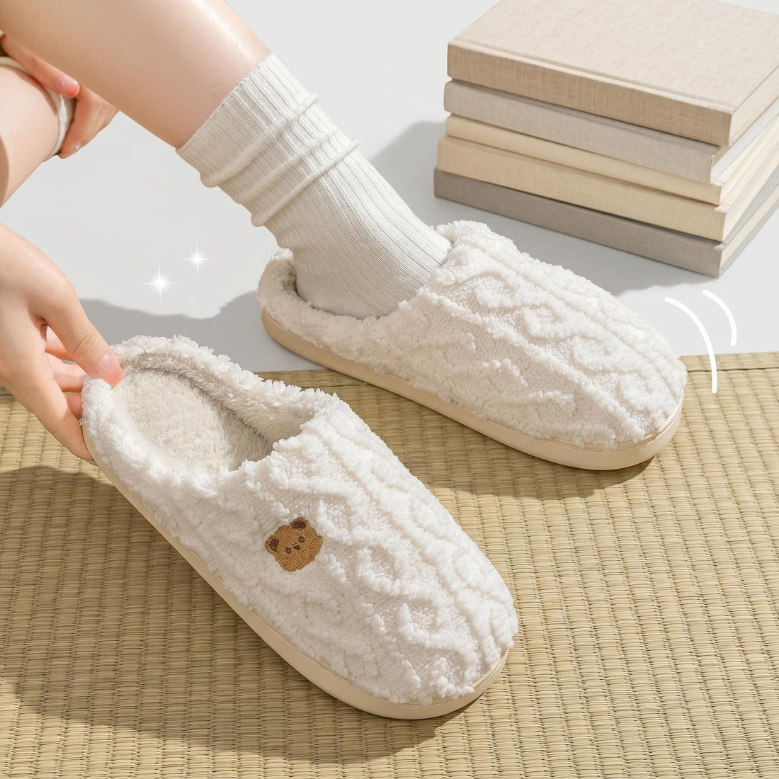 Man wearing soft, cream-colored cotton slip-on indoor slippers with a textured knit design while relaxing in a chair.