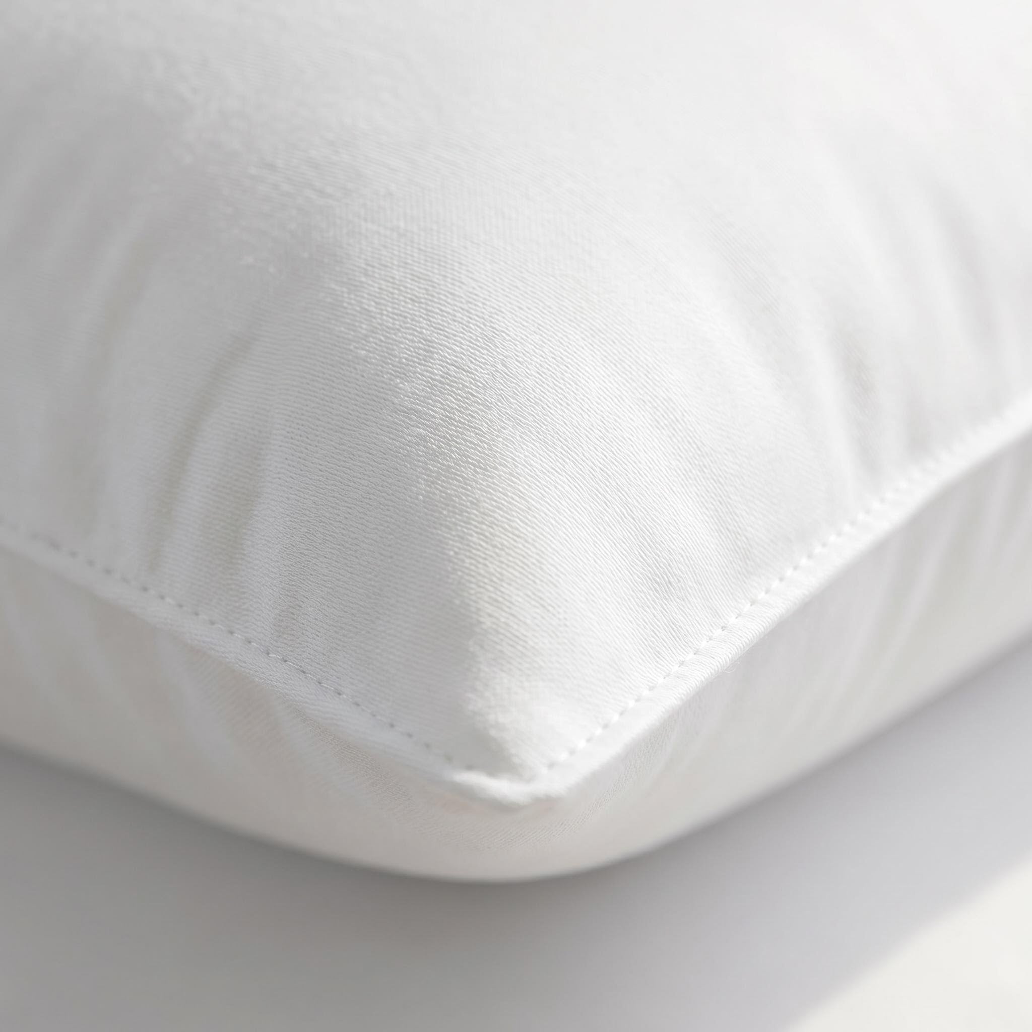 Close-up of a white CozyNest Body Pillow, showcasing its soft polyester-cotton blend fabric and plush microfiber filling.