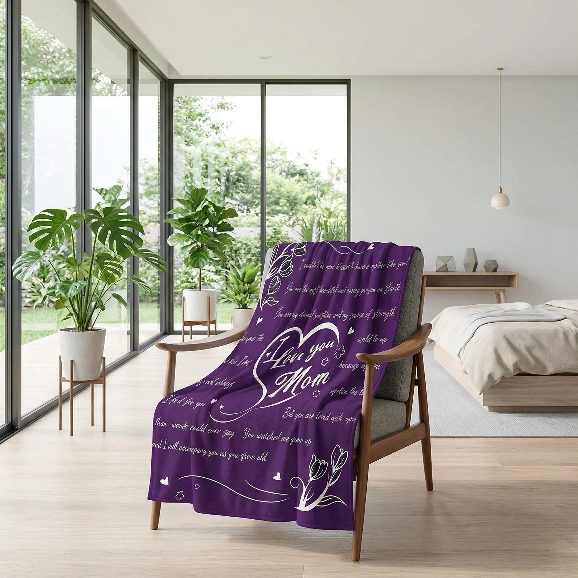 Purple "I Love You Mom" flannel throw blanket draped over a modern wooden armchair in a bright room.