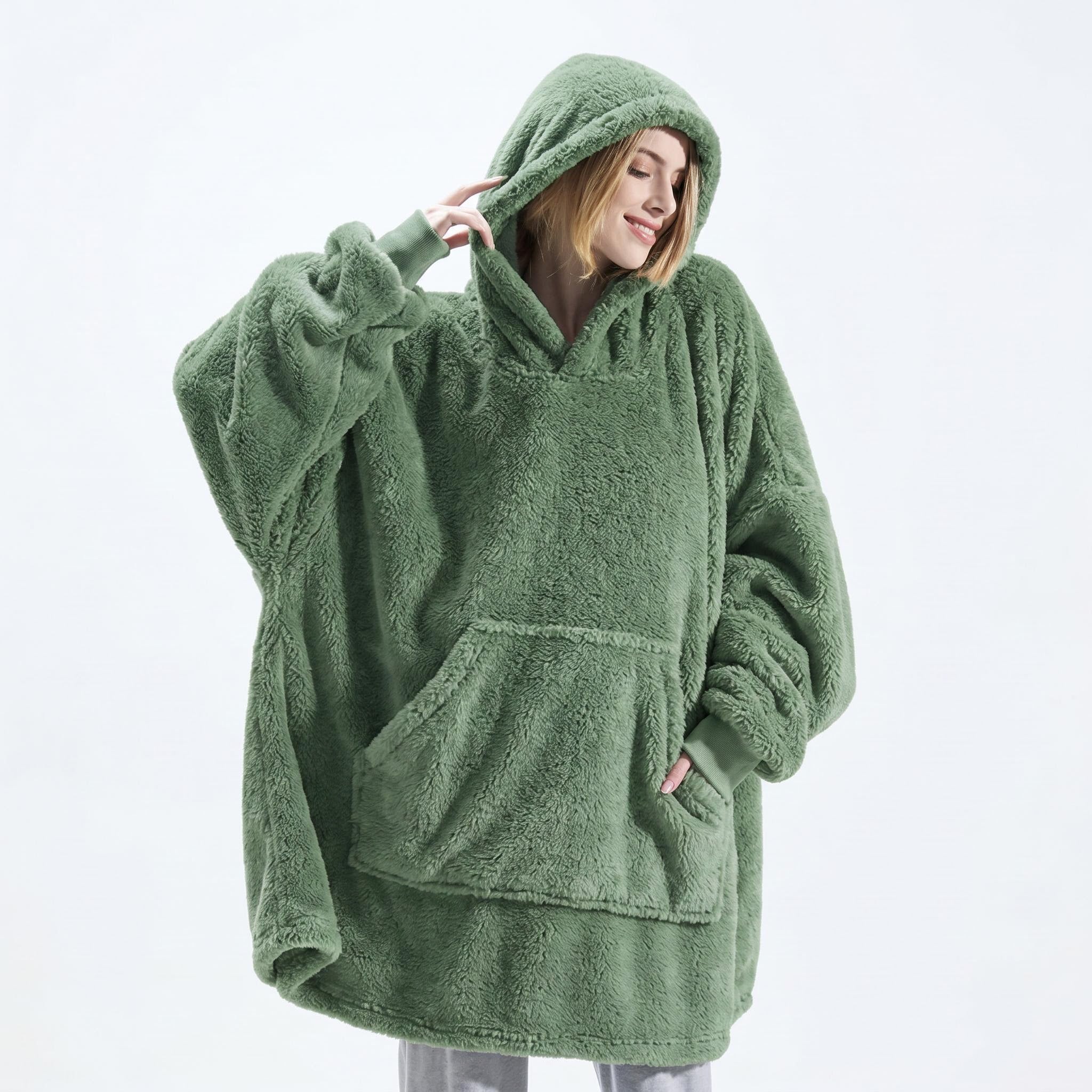 Woman in a relaxed-fit, oversized green double fleece hooded jacket with a large front pocket.