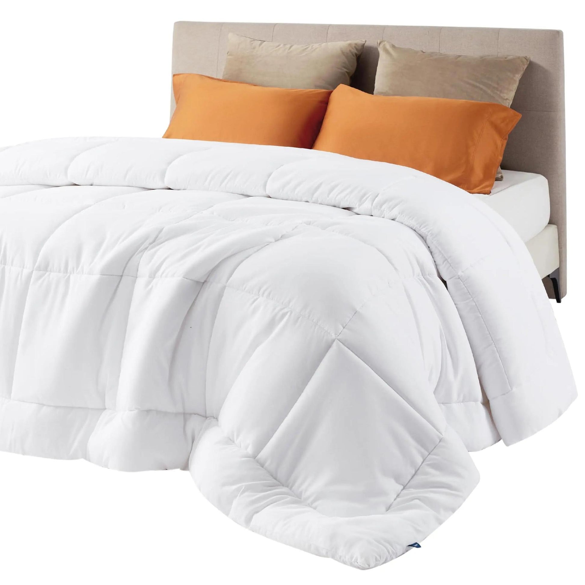 White down alternative comforter with box stitch design on a bed with orange and beige pillows.