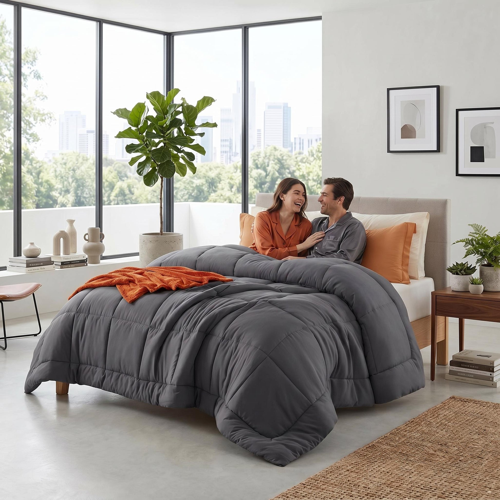 Couple laughing in bed with a dark gray down alternative comforter featuring a box stitch design.