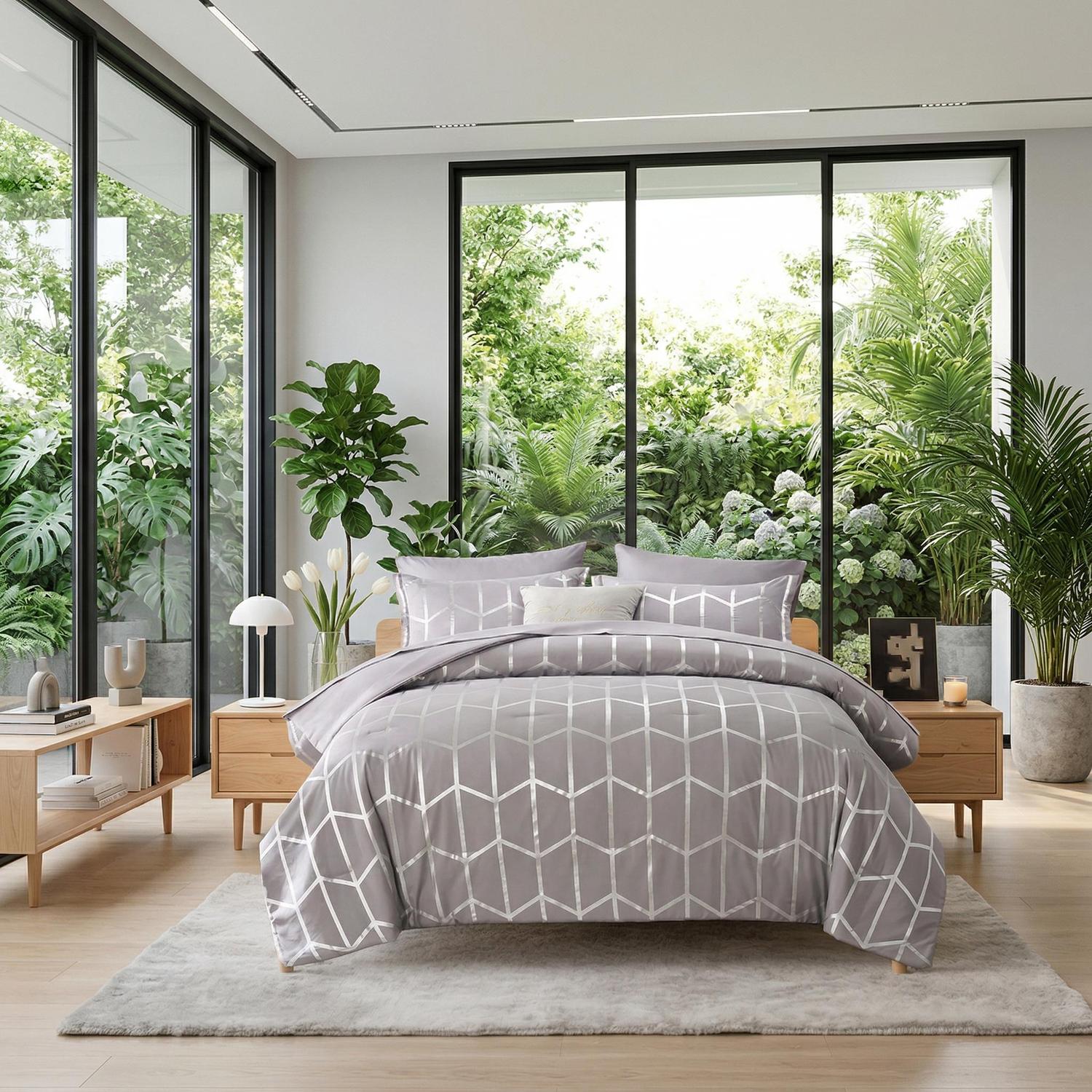 Elegant gray comforter set with a silver geometric foil design on a wooden bed in a bright room.