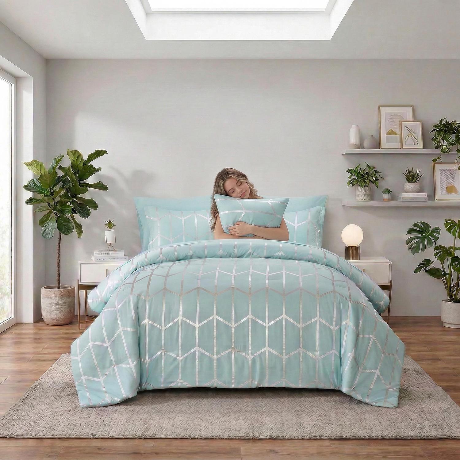Light blue microfiber comforter set with silver geometric foil design, pillow shams, and decorative pillows.
