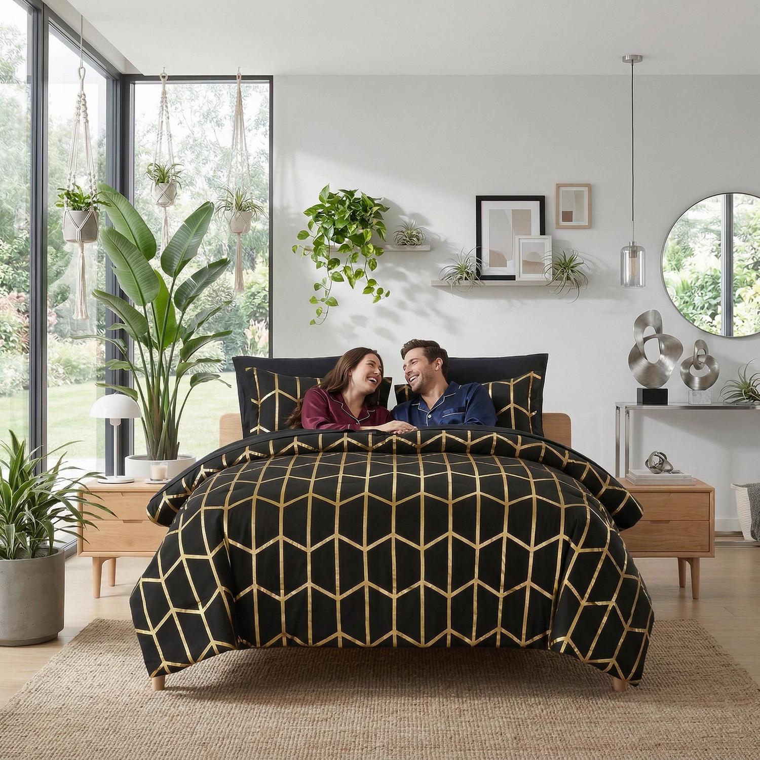 Black comforter set with gold geometric foil design on a bed with a couple.