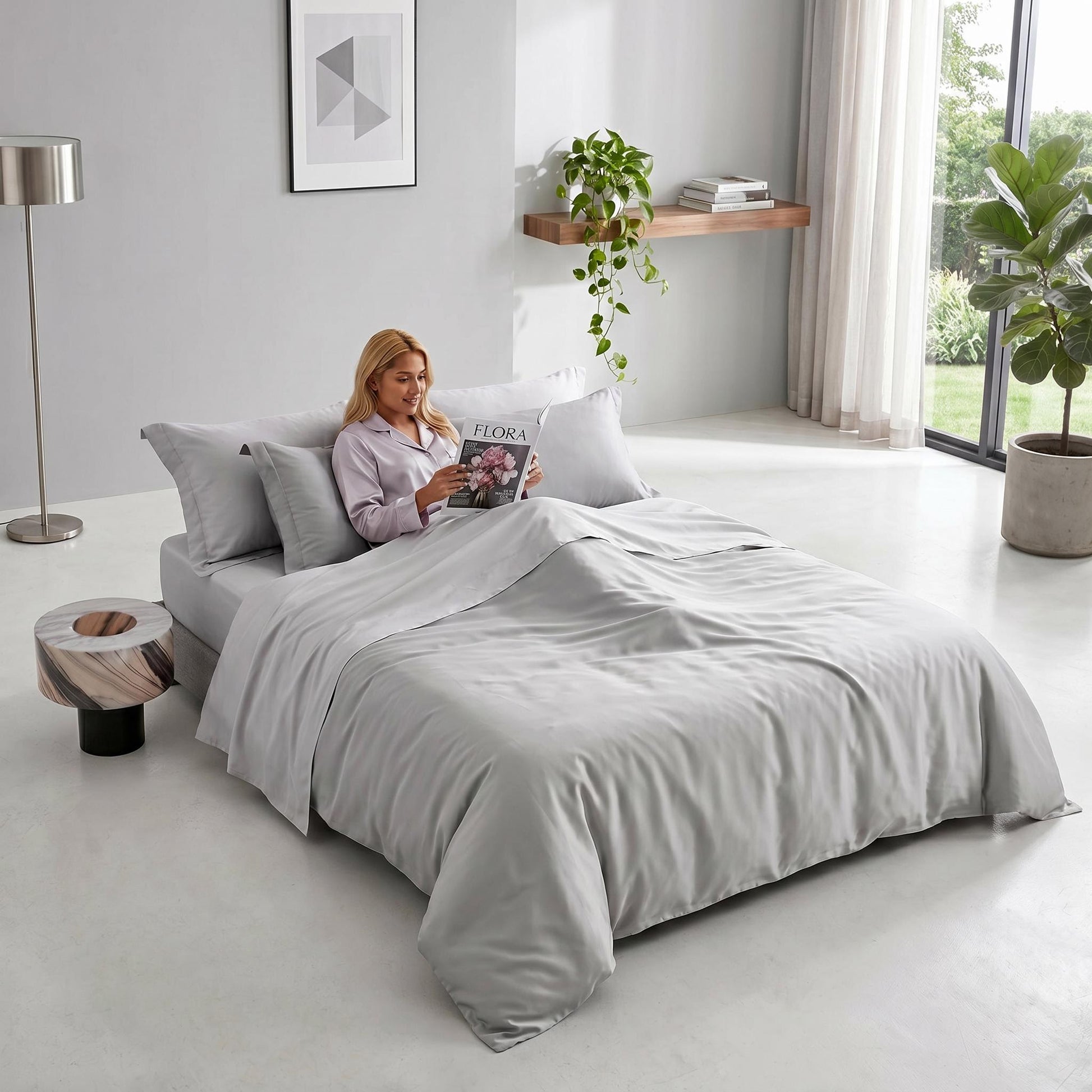 Elegant light gray organic cotton bedding set with a sateen weave on a bed in a modern bedroom.