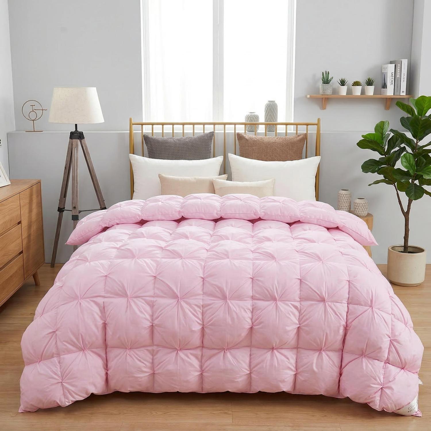 Pink goose down quilt comforter with a twist flower pattern on a bed.