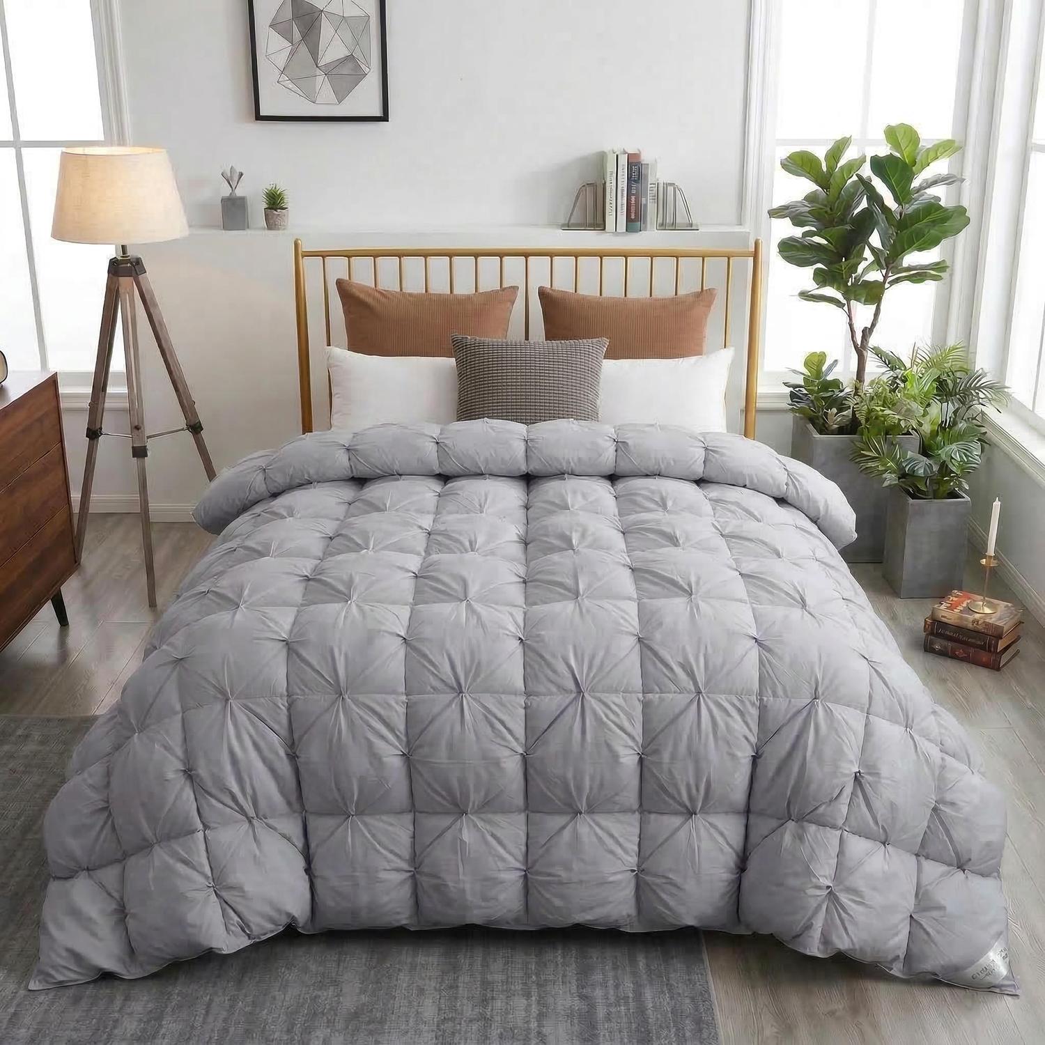 Elegant grey goose down quilt comforter with a twist flower pattern on a bed.