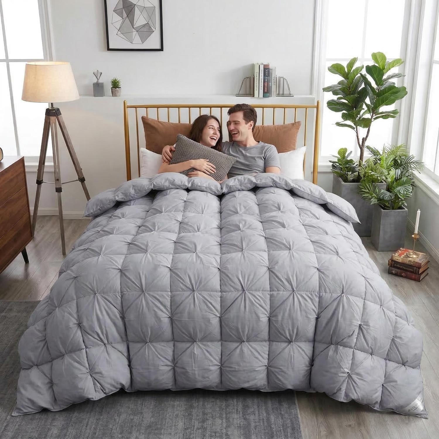 Couple under a grey goose down comforter with a twist flower pattern in a modern bedroom.