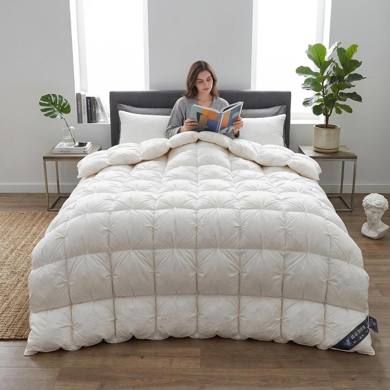 Elegant white goose down quilt comforter with a twist flower design on a bed, a woman reading.