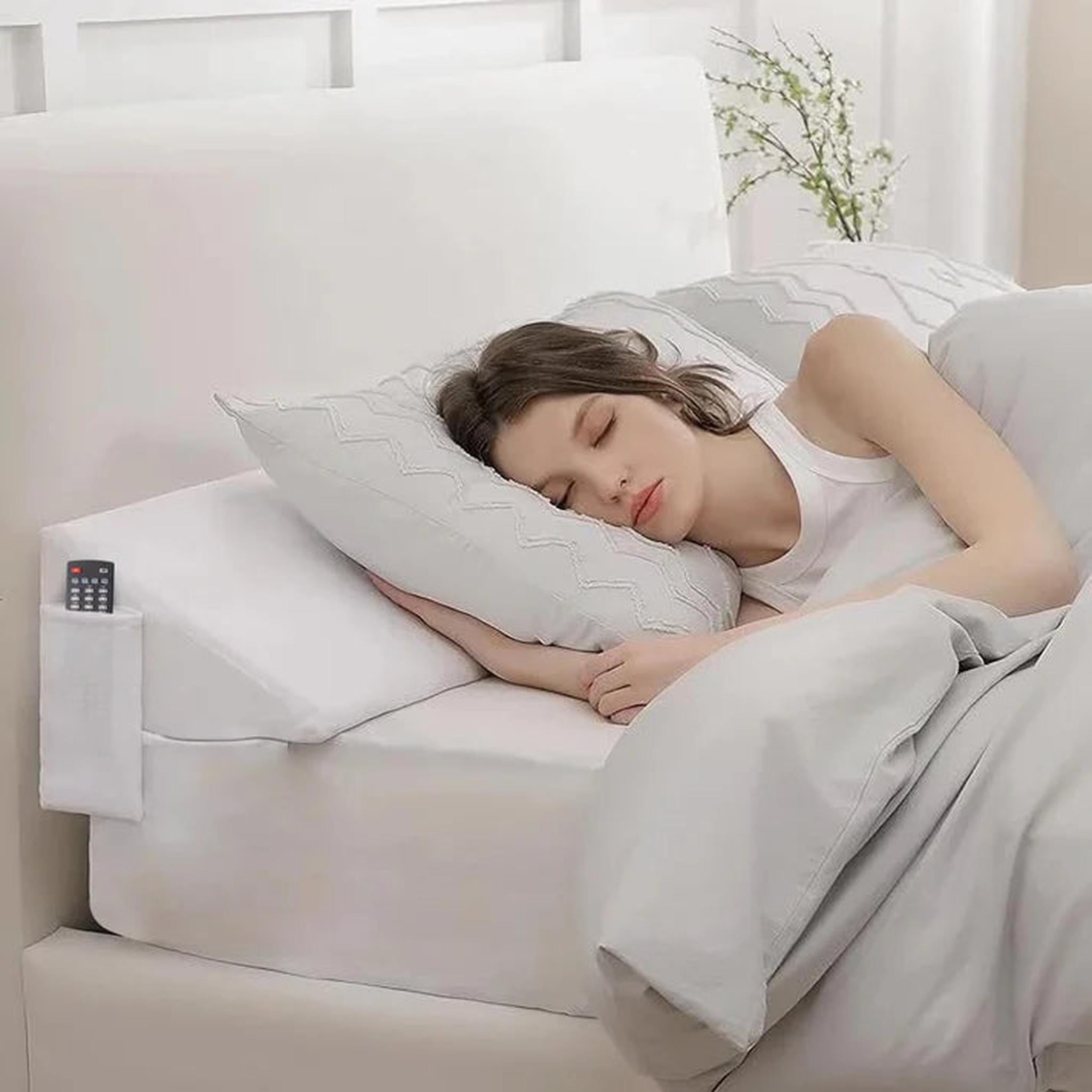 White ElevateWedge Gap Filler Pillow with side pocket, supporting a sleeping woman in a modern bedroom.