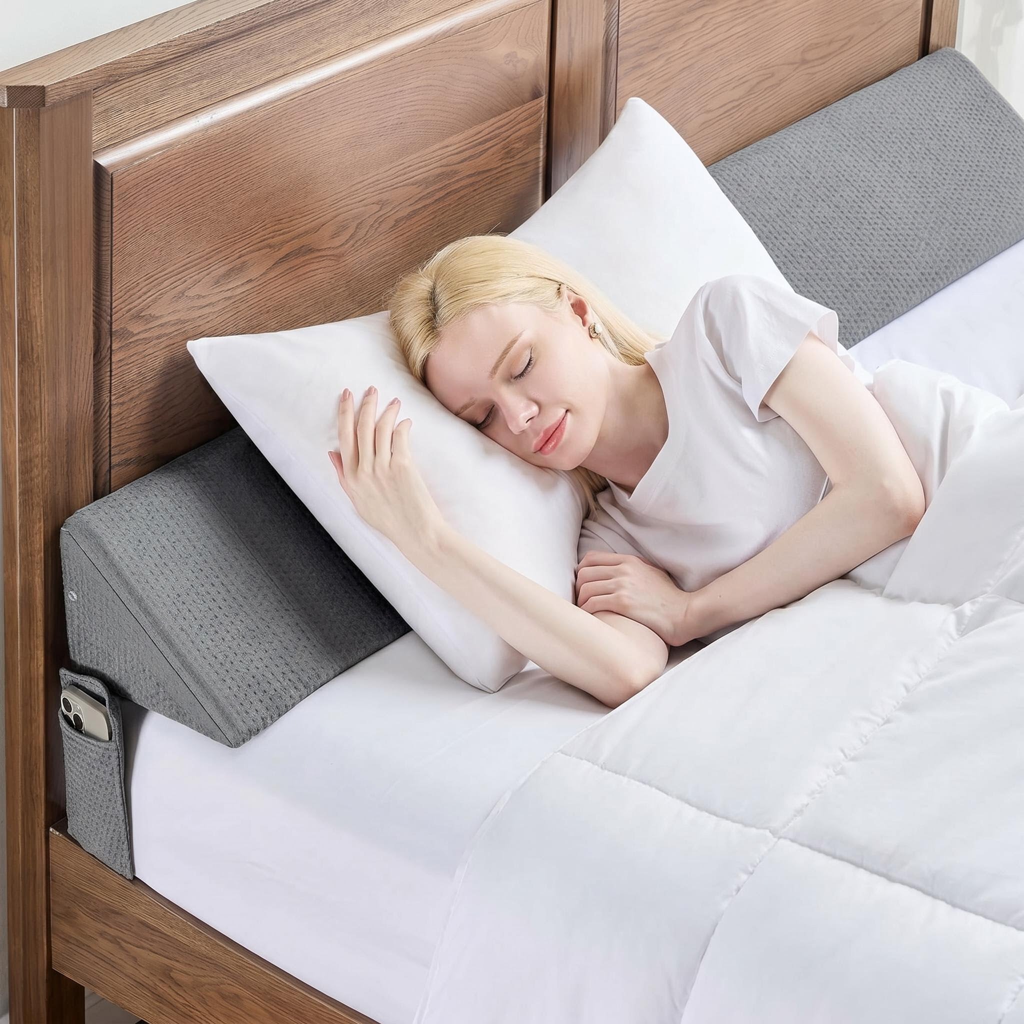 Gray ElevateWedge gap filler pillow with textured cover, filling space between a wooden headboard and white bedding.